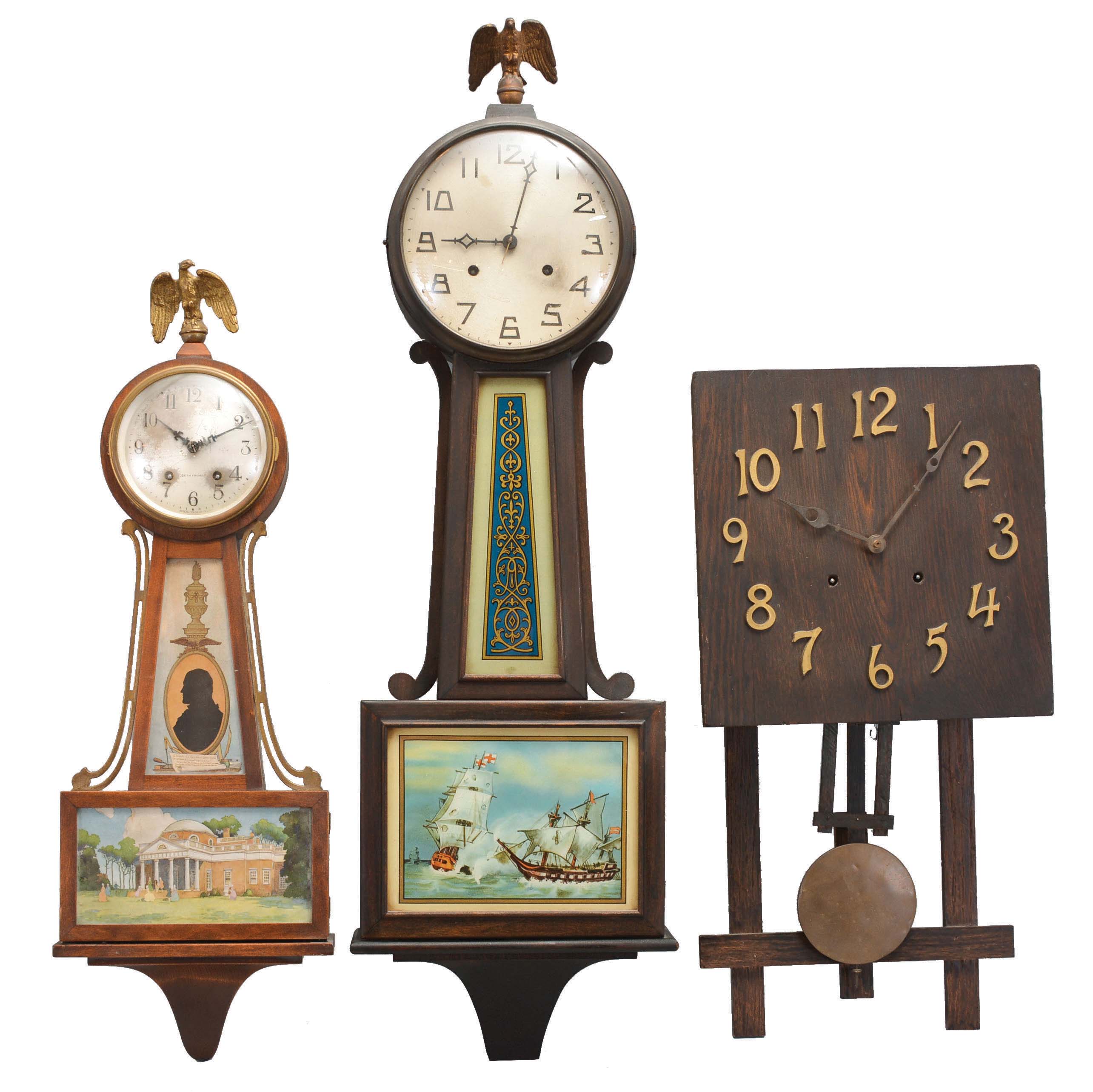 Clocks- 3 (Three) Time & Strike Wall: (1) Seth Thomas Clock Co., Thomaston, Conn., "Banjo No. 7" wall clock, 8 day, time and strike, spring driven movement in a mahogany case with a silvered brass dial and tablets featuring Thomas Jefferson and Monticello, c1929. (2) New Haven Clock Co., New Haven, Conn., "Waring" banjo clock, 8 day, time and strike, spring driven movement in a mahogany finish case with a silvered brass dial and reverse painted throat and lower tablet, c1923. (3) Connecticut, Mission style wall clock, 8 day, time and strike, spring driven movement in a dark oak case with applied bronze numerals, brass clad pendulum bob, c1910. — Antique Clocks Price Guide
