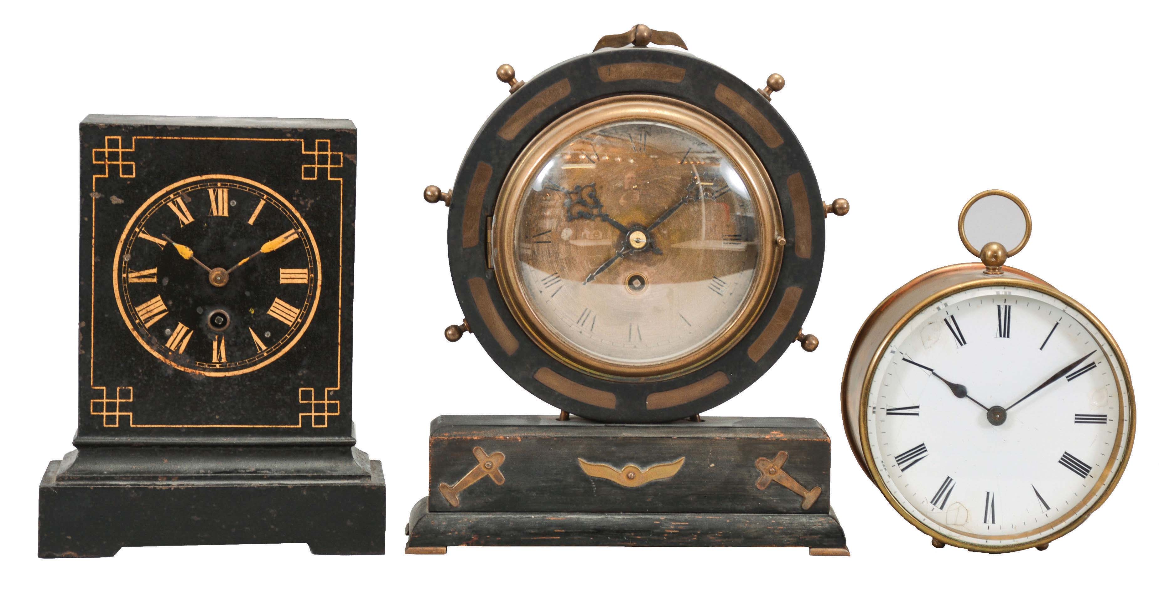 Clocks- 3 (Three) French Time-only Desk: (1) France, desk clock, 8 day, time only, spring driven movement with cylinder escapement on a black wood base with brass aviation-themed ornaments, 5 inch silvered dial with Roman numerals and blued steel hands. (2) France, desk clock, 8 day, time only, spring driven tic-tac movement with pendulum integrated with crutch in a black cast iron case with painted 4 inch dial and spade hands painted yellow. (3) France, desk clock, 8 day, time only, spring driven movement with cylinder escapement in a cylindrical brass case with ball fee and top ring holding a white enamel dial with Roman numerals and blued steel spade hands. — Antique Clocks Price Guide