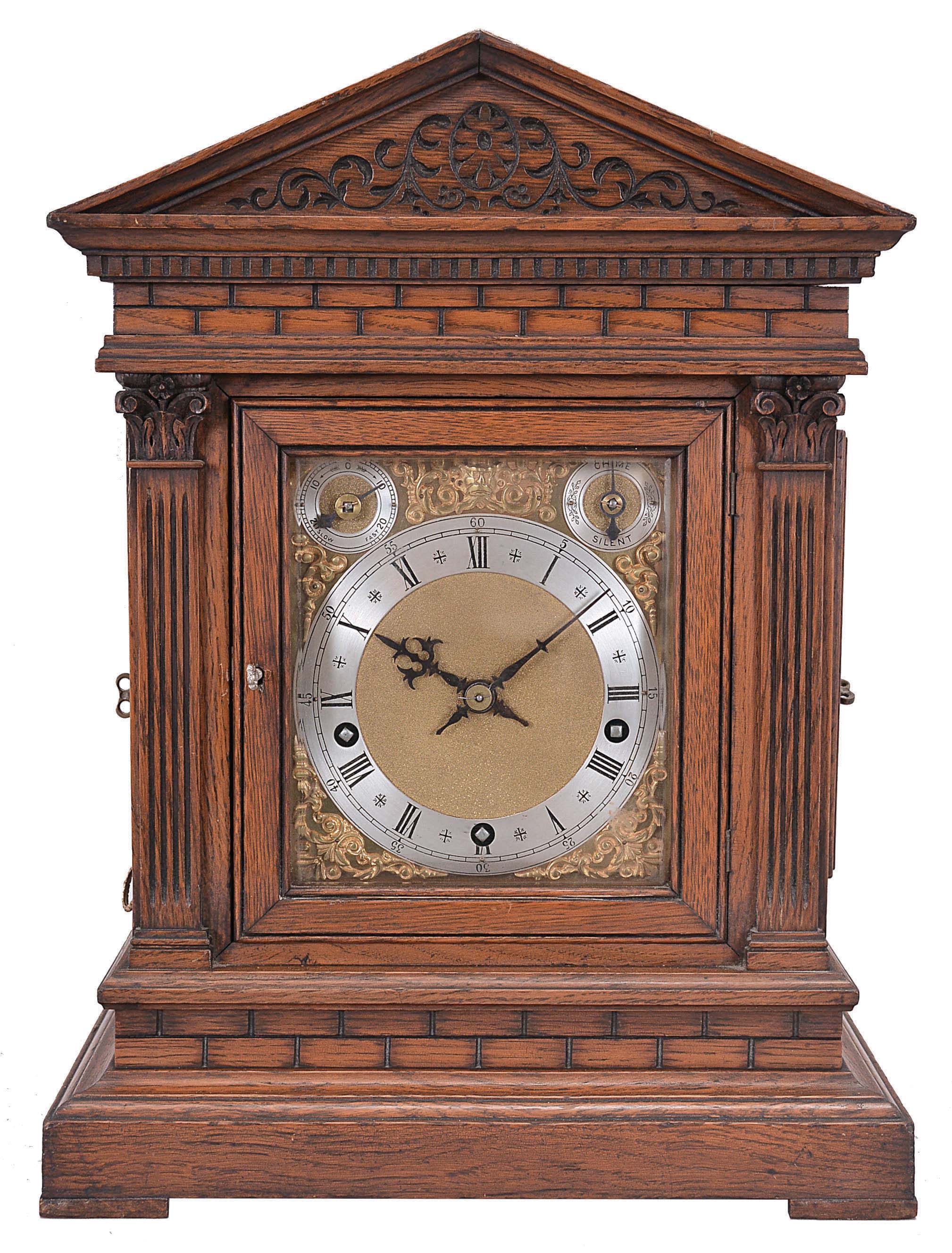 Winterhalder & Hofmeier, Schwarzenbach, Germany, bracket clock, 8 day, time and gong strike with chime playing on eight bells, spring-driven movement in an oak architectural case with fluted pilasters, frieze resembling ashlar, tympanum with carved scroll design, brass dial plate with applied cast spandrels, silvered chapter ring with Roman numerals, subsidiary rate adjustment and chime / silent dials, blued steel hands. — Antique Clocks Price Guide