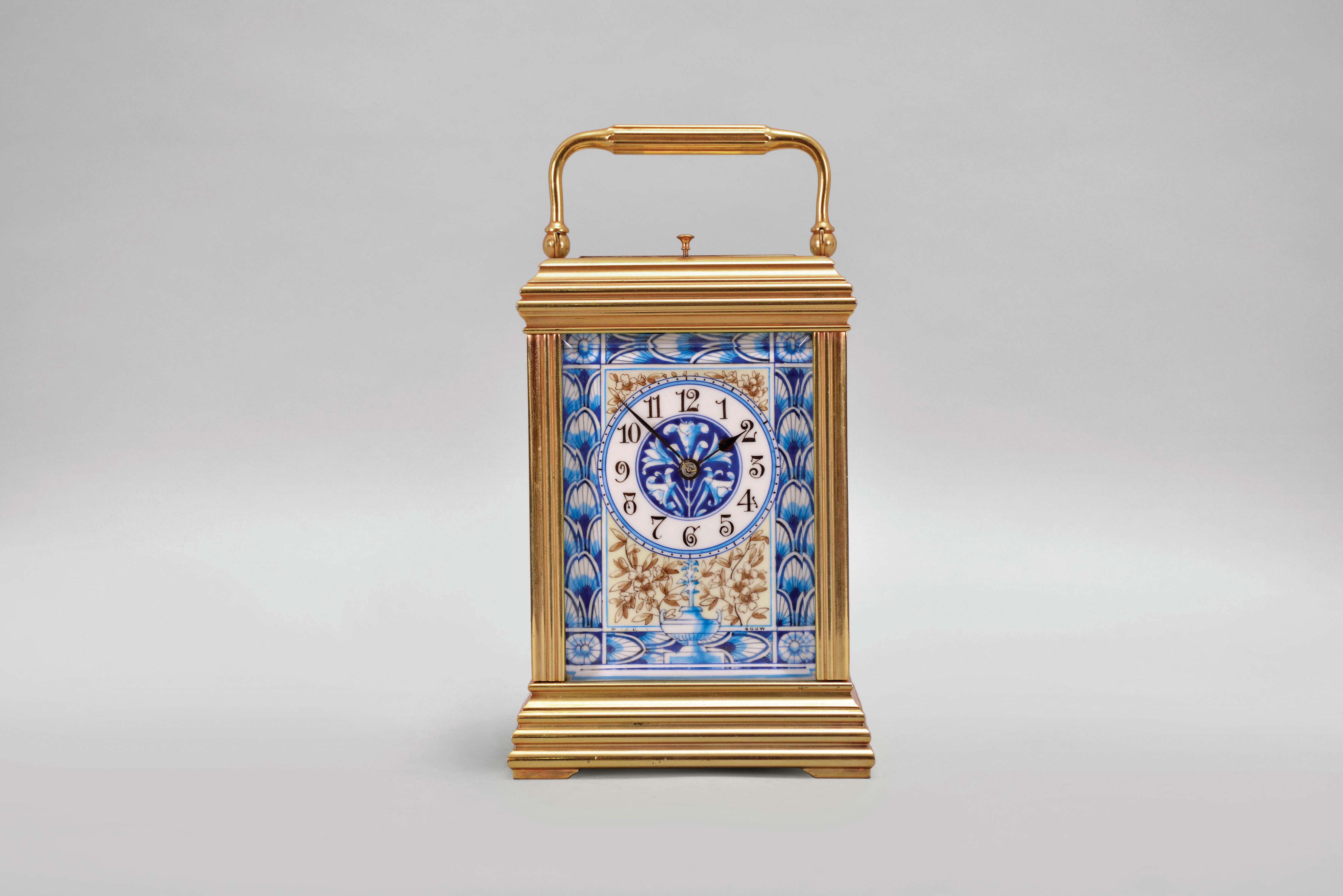 France, attributed to Gaye, Lamaille, & Co., a fine, Aesthetic Movement, porcelain paneled hour repeating carriage clock, the gilt, Cannelee variant case with folding handle, the sides set with panels depicting a potted flower in blue, on a cream ground, also with floral ornament, and with blue, wheatear border, the Arabic numeral dial with ornament matching the side panels, blued steel spade and whip hands, two train, 8 day movement with lever platform, striking the hour and half hour in passing, and repeating the last hour on demand, the back plate marked "Patent Surety Roller", and 1813 — Antique Clocks Price Guide