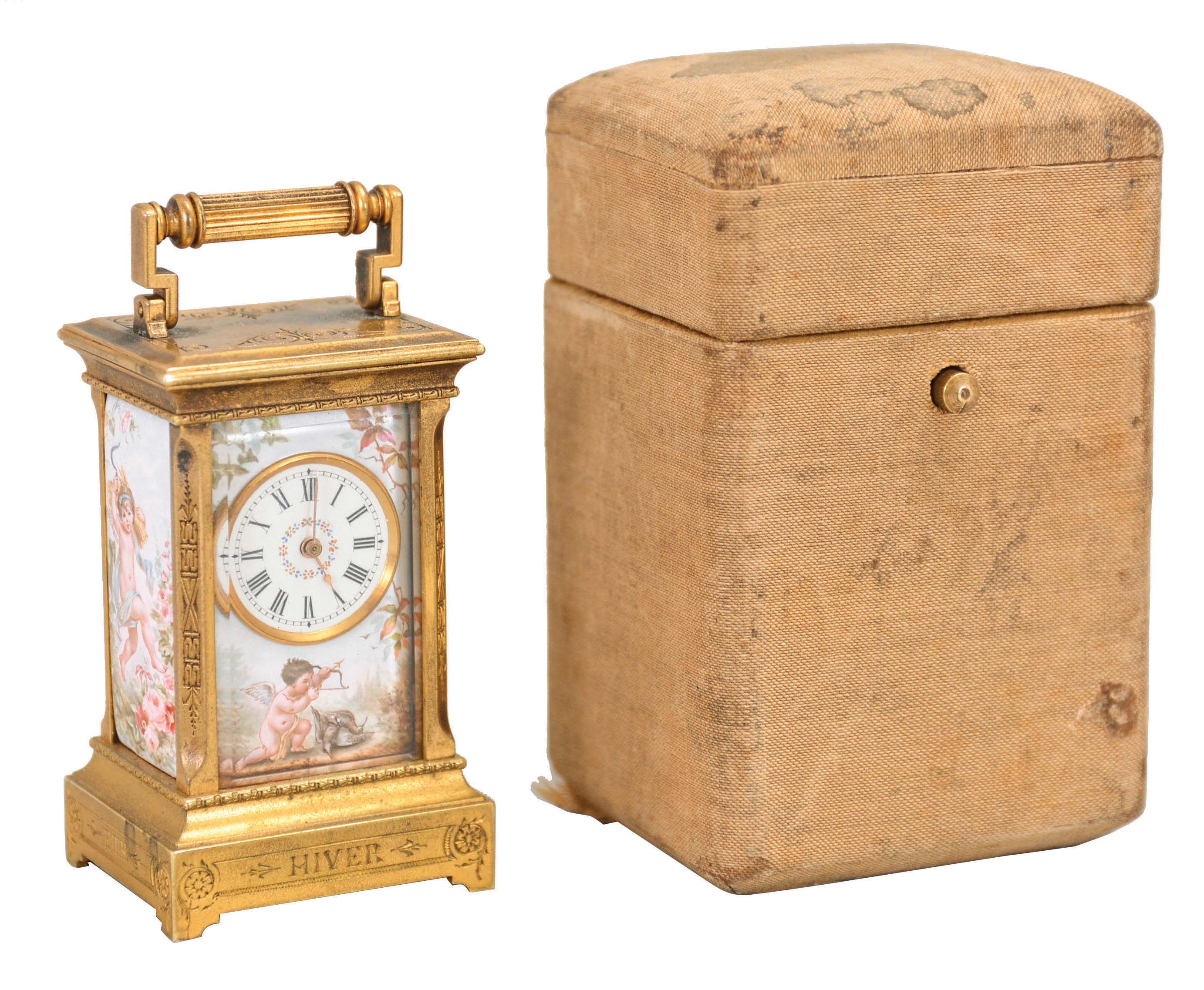 Switzerland, an exceptional miniature carriage clock with enameled panels, the engraved, gilt case nearly 3/4 inches smaller than a mignonette No. 1, the sides and back with polychrome enamel scenes of disporting putti, the Roman numeral enamel dial with mask matching the exterior panels, each representing one of the four seasons, the base with engraved titles, "Hiver, Automne, Printemps, Ete", 30 hour, timepiece movement with cylinder escapement, and fabric covered travel case with key — Antique Clocks Price Guide