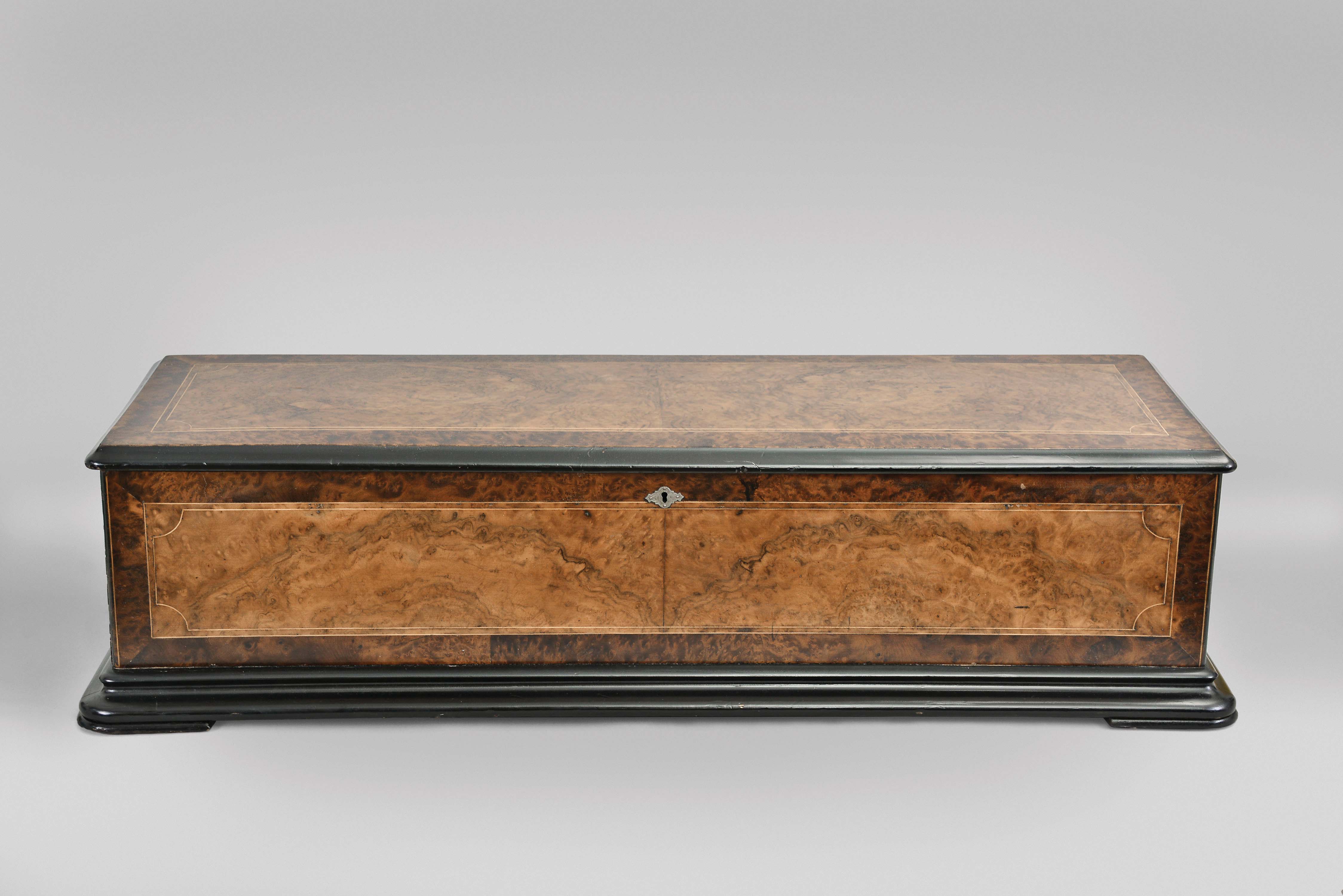 George Baker and Co., late G. Baker-Troll & Co., Geneva, Switzerland, 21" cylinder music box playing 12 tunes on three combs over three octaves in a burl walnut and Carpathian elm burled veneer case with ebonized accents — Antique Clocks Price Guide