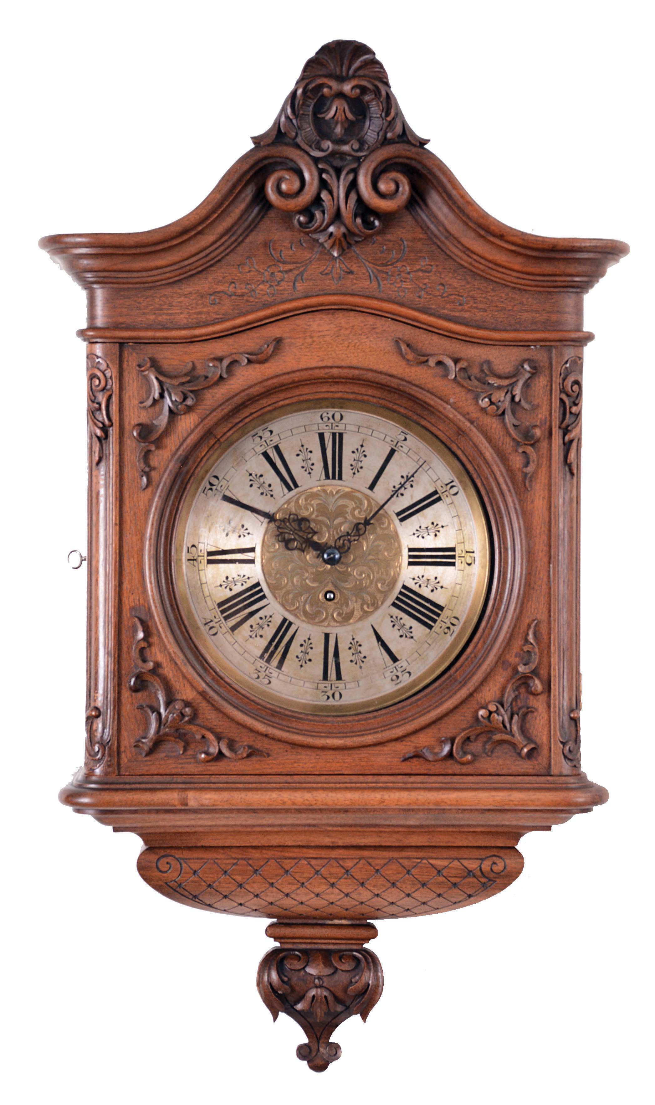 Gustav Becker, Freiberg, Germany, cartel clock, 8 day, time only, spring driven movement in a walnut veneered case in the second baroque style with carved scrolls and floral elements with a roman numeral silvered brass dial, and pieced blued steel hands. — Antique Clocks Price Guide