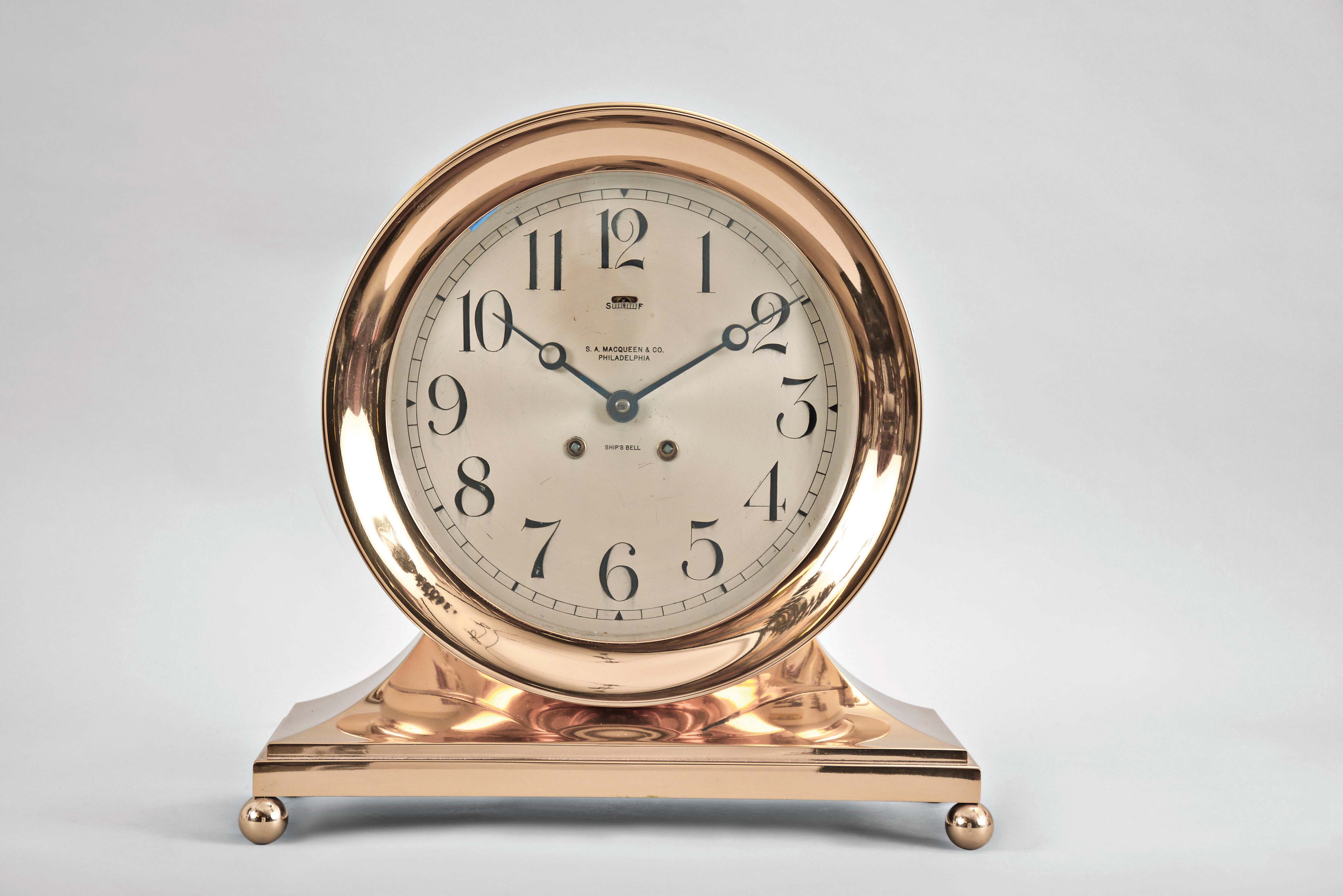 Chelsea Clock Co., Chelsea, Mass., "Commodore Base & Ball", 8 day, time and strike brass lever movement ship's bell mantel clock with an 8 1/2" dial retailed by S. A. MacQueen & Co., Philadelphia. Serial No. 86426. — Antique Clocks Price Guide