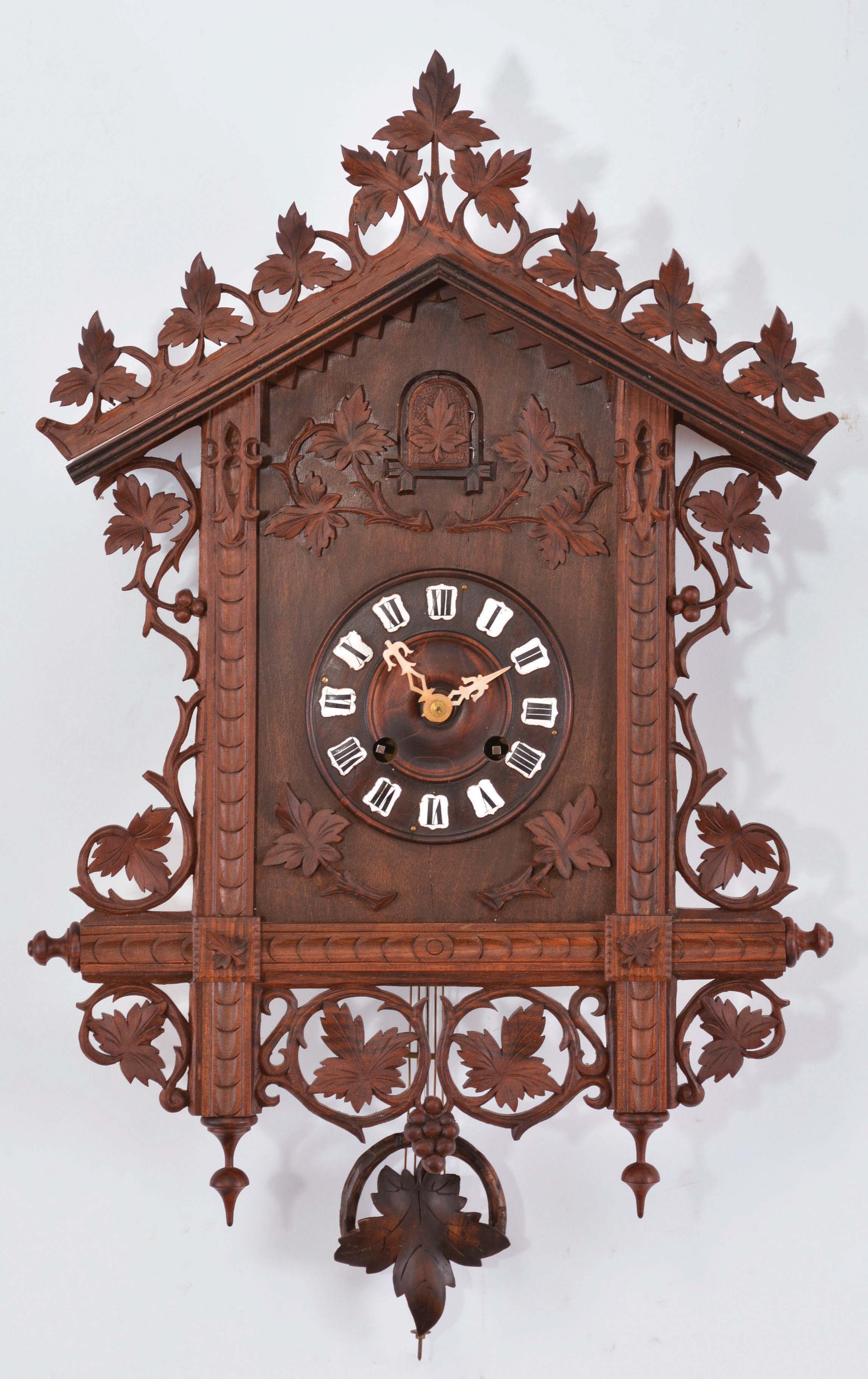 Black Forest, Germany, railway house cuckoo clock, 3 day, time and strike with calling cuckoo bird, spring driven two train movement with a single fusee on the strike train in a softwood case with hardwood carvings, white enamel cartouche numerals on the dial, and bone hands. — Antique Clocks Price Guide