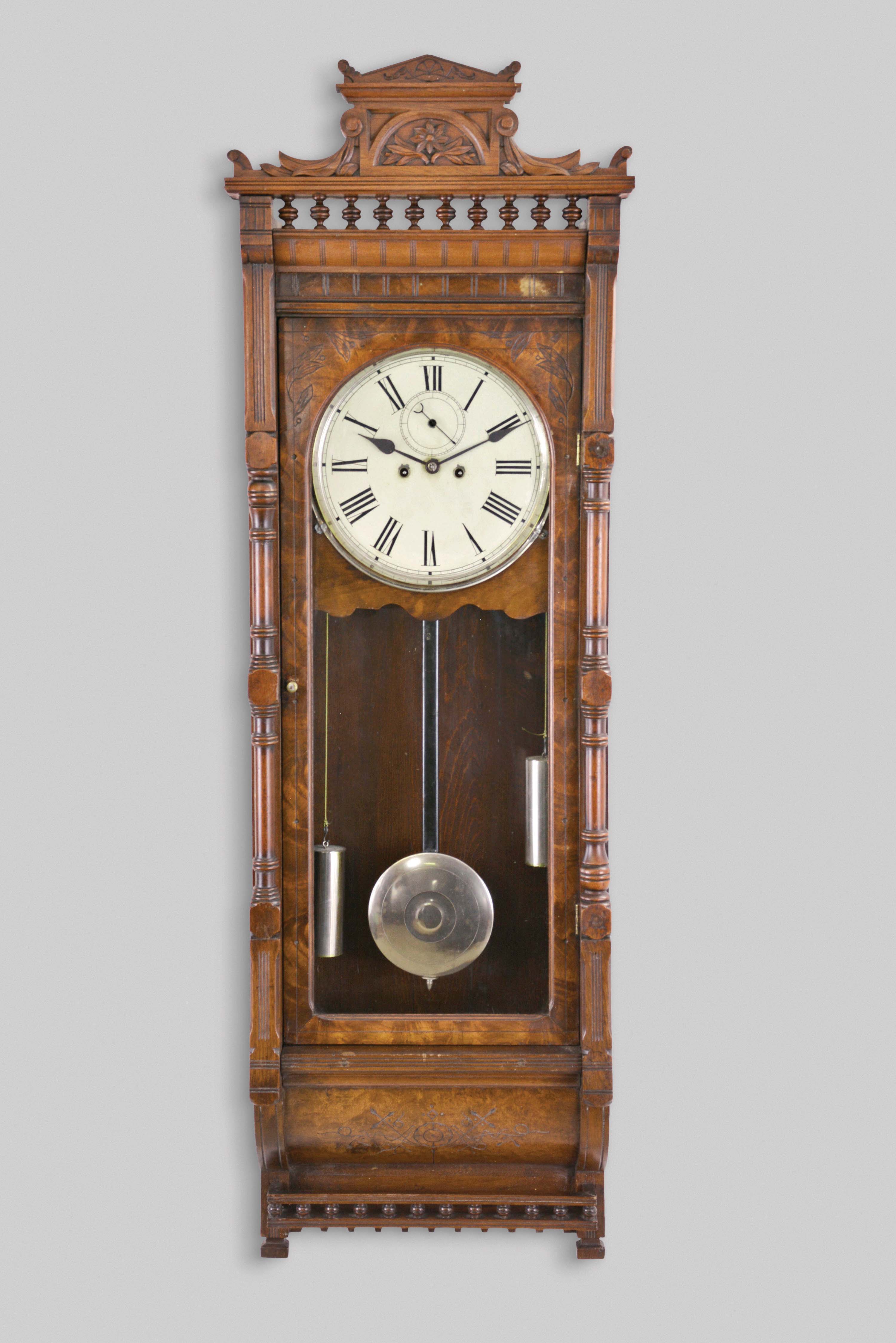 Waterbury Clock Co., Waterbury, Conn., "Regulator No. 4", 8 day, double weight driven brass movement wall timepiece. This case was also used by Welch for their "Regulator G" model. Although unmarked, this one an A- frame movement similar to the solid plate A-frame movements used in some other Waterbury regulators. — Antique Clocks Price Guide