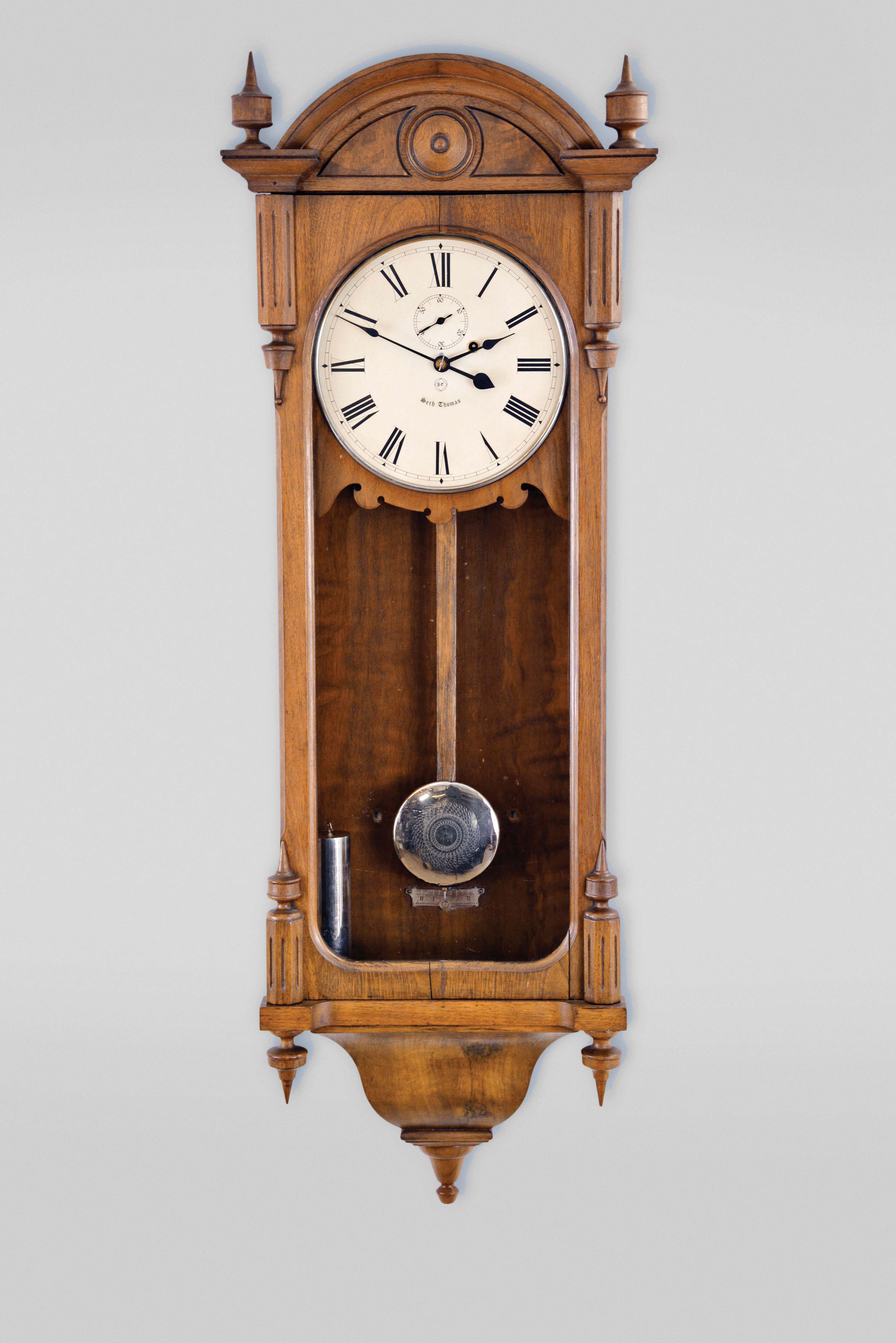 Seth Thomas Clock Co., Thomaston, Conn., "Regulator No. 6" wall hanging clock with a weight driven, 8 day, timepiece movement with dead-beat escapement and maintaining power in a walnut case. — Antique Clocks Price Guide