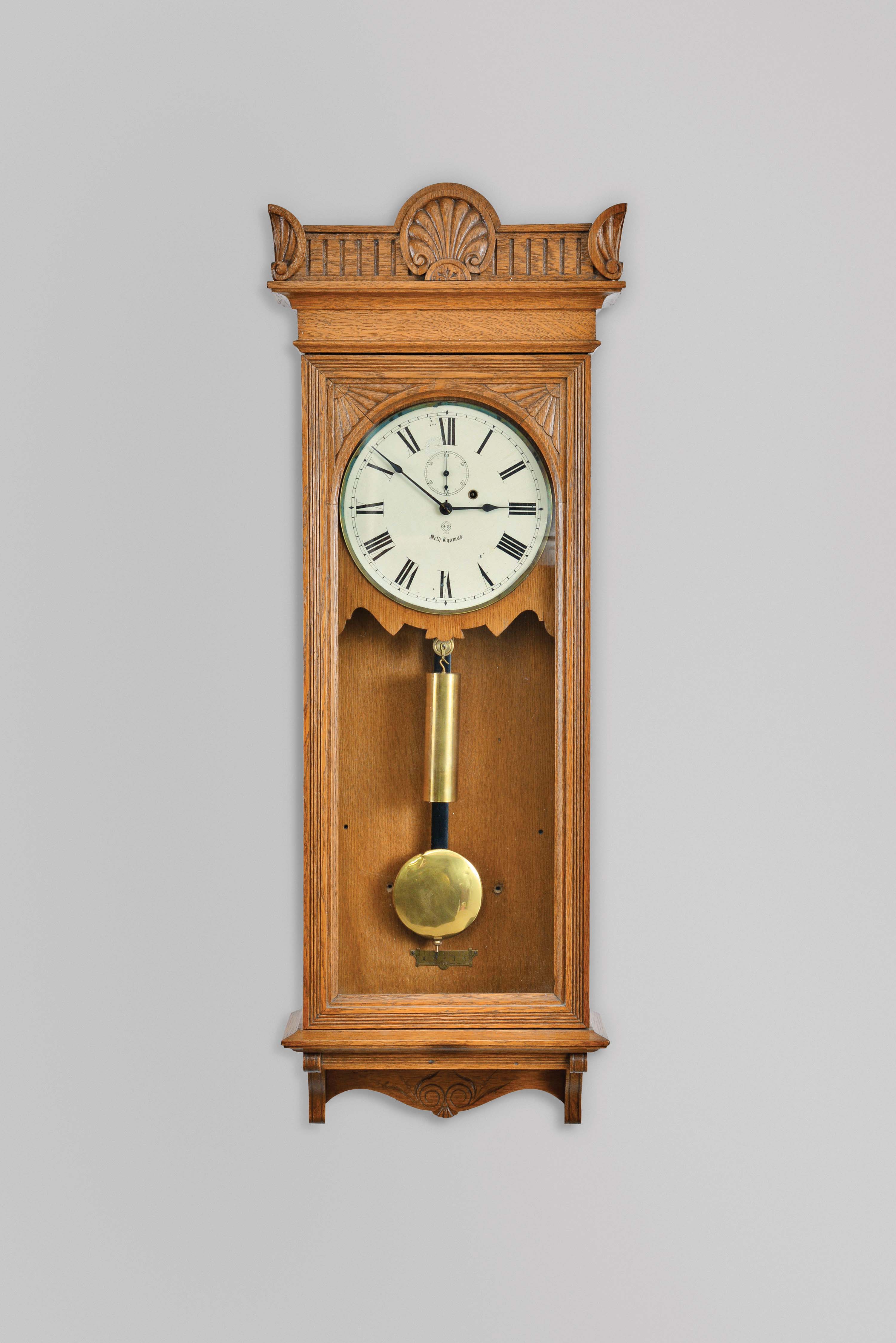 Seth Thomas Clock Co., Thomaston, Conn., "Regulator No. 9" wall hanging clock with a weight driven, 8 day, timepiece movement with dead-beat escapement and maintaining power in an oak case. — Antique Clocks Price Guide
