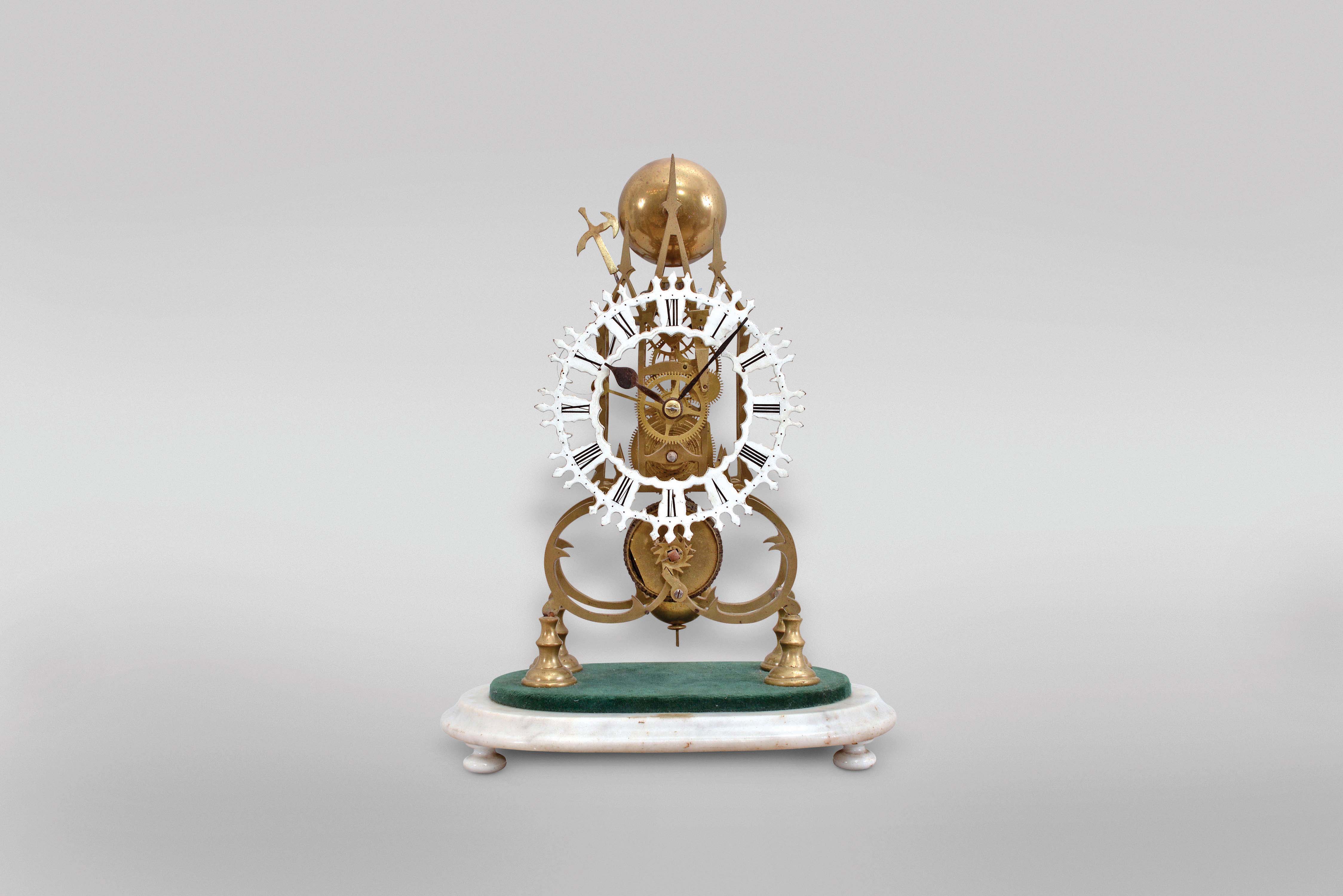 England, single train skeleton clock with passing strike, the brass frames with gothic style fretting, roman numeral, skeletonized, white painted dial, blued steel spade and poker hands, 4 wheel fusee movement with four spoke crossings, and striking a single blow at the hour on a bell, mounted to an oblong, green velvet lined, white marble base — Antique Clocks Price Guide
