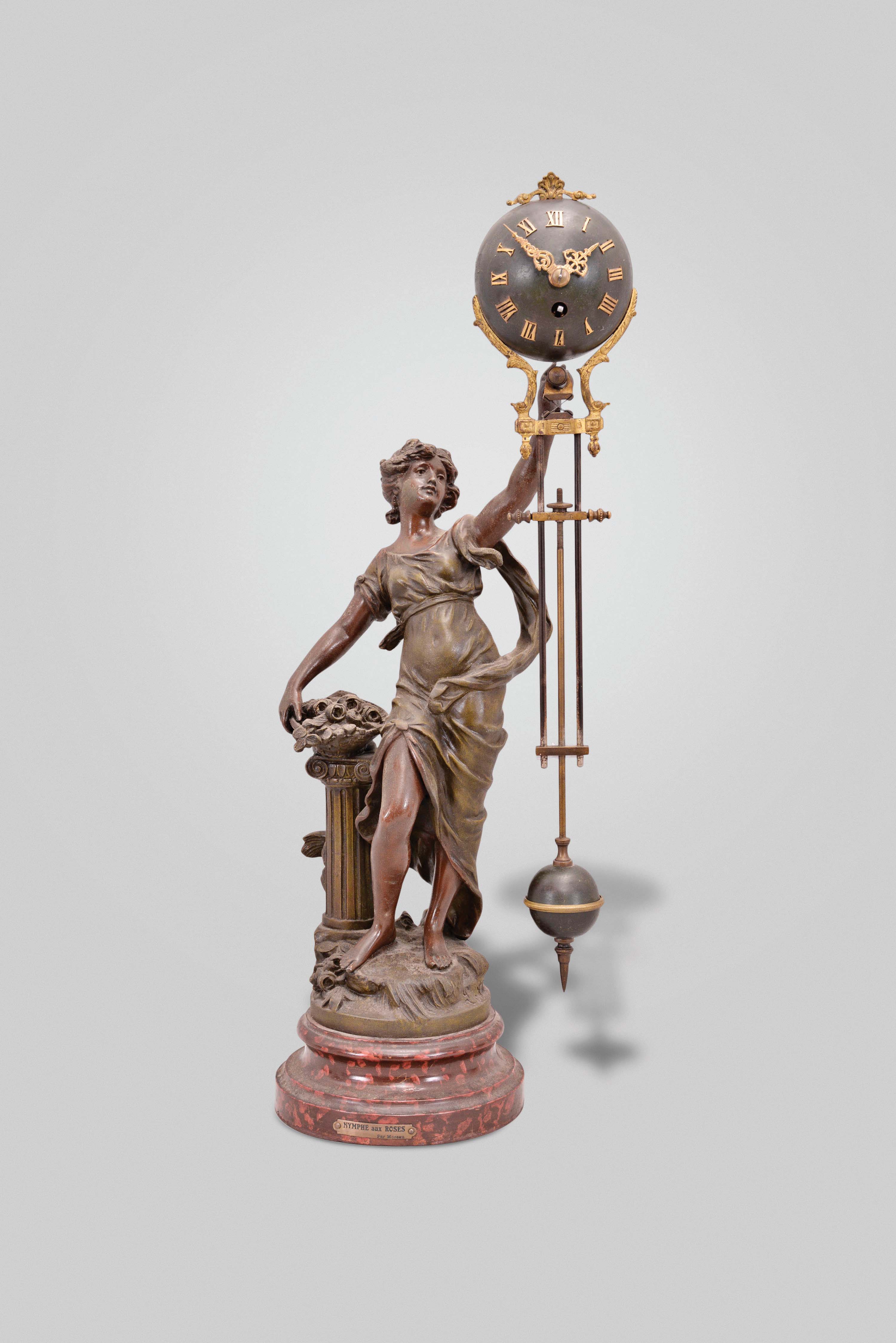 France, an attractive, small swinger, "Nymph with Roses", turned wooden, faux tortoise shell base with engraved plaque "Nymphe aux Rose par Moreau", supporting the patinated spelter figure of a young woman, in flowing dress, with column and basket of flowers, the swinging timepiece held aloft in her left hand, the 8 day movement contained in a patinated sphere with applied roman numerals and Louis XV style hands, and attached to the faux gridiron, compound pendulum, clock movement and pendulum marked "S.E.F.I.A. France" — Antique Clocks Price Guide