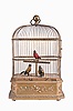 France, attributed to Bontems, automata with three caged, singing birds, the gilt cage having a rectangular wooden base with canted corners, decorated with foliate ornament, and containing the keywound mechanism, the cage containing brightly colored, life size songbirds who vocalize, turn their heads and flick their tails in turn when activated