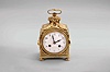 France, a late 19th century Pendule d'Officier style table clock, gilt brass case with applied foliate ornament and with ouroboros handle, arabic numeral white enamel dial, blued steel hands, 8 day, two train movement with lever platform