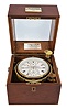 D. McGregor and Co., Glasgow & Greenock, a two day marine chronometer with double auxiliary balance, 10 jewel fusee movement with Earnshaw's escapement, and freesprung, cut bimetallic balance with Poole's and Eiffe's auxiliary compensation, diamond endstone, and blued steel helical balance spring, Roman numeral silvered dial with wind indicator, gold spade and poker hands, contained in a lacquered brass bowl, and mounted in an associated two tier mahogany box with gimbals, bevelled glass top, and lacquered brass furniture, serial #J/5817