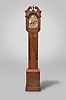 Reproduction dwarf tall clock, signed "JACKSON ETON", 8 day, time and strike, brass weight driven movement in a mahogany case with broken arch top, center flame finial above fluted plinth, tombstone door on trunk flanked by fluted columns and turned and fluted columns flanking hood door. The brass dial with silvered chapter ring has name boss and cast corner spandrels.