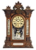 William L. Gilbert Clock Co., Winsted, Conn., "Amphion" shelf clock with a spring driven, 8 day, time and strike movement in a walnut case and cut glass mirror panels in the case.