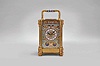 France, an unusual, champleve enamel decorated, pillars style hour repeating carriage clock, the gilt case with outset corners, turned feet and columns, the base, frieze, and top with scrolling foliate designs, and decorated with polychrome enamel colors on a turquoise ground, the front of base with engraved presentation "Sir Donald Currie, K.C.M.G., M.P. In Remembrance of a Pleasant Cruise in the Pembroke Castle, Septr. 1883, from J.C.", Arabic numeral champleve enamel dial with fine engraving and matching the exterior colors, blued steel distaff hands, two train movement with lever platform, striking the hours and half hour in passing, and repeating the last hour on demand