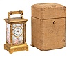 Switzerland, an exceptional miniature carriage clock with enameled panels, the engraved, gilt case nearly 3/4 inches smaller than a mignonette No. 1, the sides and back with polychrome enamel scenes of disporting putti, the Roman numeral enamel dial with mask matching the exterior panels, each representing one of the four seasons, the base with engraved titles, "Hiver, Automne, Printemps, Ete", 30 hour, timepiece movement with cylinder escapement, and fabric covered travel case with key