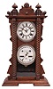 Waterbury Clock Co., Waterbury, Conn., "Calendar No. 40" shelf clock with a spring driven, 8 day, time and strike movement with a patented perpetual calendar mechanism in a walnut case.