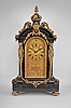 A. Ecalle, Horloger de la Marine, 93- 94 Palais Royal, Paris, a monumental Belgian slate, gilt bronze mounted, grand sonnerie mantel clock, on gilt, gadrooned feet, the base with incised panels and deep cavetto molding, and hung with a gilt, fruit and foliate festoon, the recessed corners with gilt caryatids supporting the cavetto molded cornice and arch top, the arch with central lion mask and foliate ornament issuing from its mouth, the top with gilt scrolls flanking a stone plinth surmounted by a turned, gadrooned and acanthus ornamented finial, engraved, gilt dial with scrolling foliage, Roman numeral chapter ring and subsidiary sonnerie/silence selector, and with retailers name and address within a blank reserve below the dial, finely cut and finished blued steel hands, and massive three train, quarter striking fusee movement, sounding the quarters and hours on five gongs