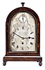 Ellicott and Smith, 17 Royal Exchange, London, a regency rosewood bracket timepiece, round top case with turned finial on a molded base with turned feet, sides with glazed, fish scale fret, signed Roman numeral silvered dial with blued steel hands and pointer for regulation, single train fusee movement with recoil escapement and rise and fall regulator, the back plate signed and with wheatear engraved border