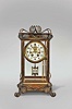 William L. Gilbert Clock Co., Winsted, Conn., "Ruskin" crystal regulator shelf clock with a spring driven, 8 day, time and strike visible escapement movement with patent self adjusting beat in a polished brass case. The hour strike is on a cathedral gong and the half hour strike on a separate cup bell.