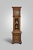 Anton Jezek, Wien, Austria, 30 day, time, strike & grande sonnerie, weight driven movement in a two piece carved walnut case with carved and turned half columns flanking dial, carved fleur-de-lis style trim over trunk door glass over a base with a single drawer, cabinet and two carved and turned 3/4 columns resting on bun feet. The intricately engraved nickel plated dial has blue numerals on raised engraved brass plaques with maker's signature "Ant. Jezek" and matching pendulum disc and weights.