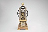 France, possibly Andre Romain Guilmet, a rare, automated, oscillating cylinder steam engine timepiece, the honey onyx square base on gilt feet, and supporting the black bronze boiler with cove molded top and bottom, below the engine itself, comprised of a large, A frame supported, spoked flywheel, connected to a rocking cylinder through a cranked linkage, the movement powering the automation contained in a black enclosure behind the engine, the enclosure top with a rotating governor in a bell shaped frame behind the wheel, surrounded by four silvered columns, and surmounted by an X shaped, arched frame with central spherical finial, the 11 jewel lever platform movement with Roman numeral silvered dial and blued steel Breguet style hands