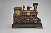 France, a rare, automated, patinated bronze locomotive form compendium, the stepped, black slate base on gilt feet with patinated rails below the large, steam locomotive, the darker surfaces highlighting the nickel, brass, and copper appointments, the engine front with cow catcher, the boiler with aneroid barometer, bell, steam dome with valve and flared stack with centigrade thermometer, the cab with shallow pitched roof, slender columns at the corners, and containing the clock and dial, a concealed movement in the base providing power to drive the six wheels, connecting rods, and piston, roman numeral brass dial, blued steel Breguet style hands, and 8 day, two train pendule de Paris movement