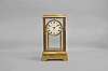 Eureka Clock Co., Ltd., London, type 1, 1000 day electric clock in a polished brass, four glass case, the batteries concealed in the base, signed Roman numeral white enamel dial, blued steel spade hands, and movement with spotted plates and large bimetallic balance, serial #2777