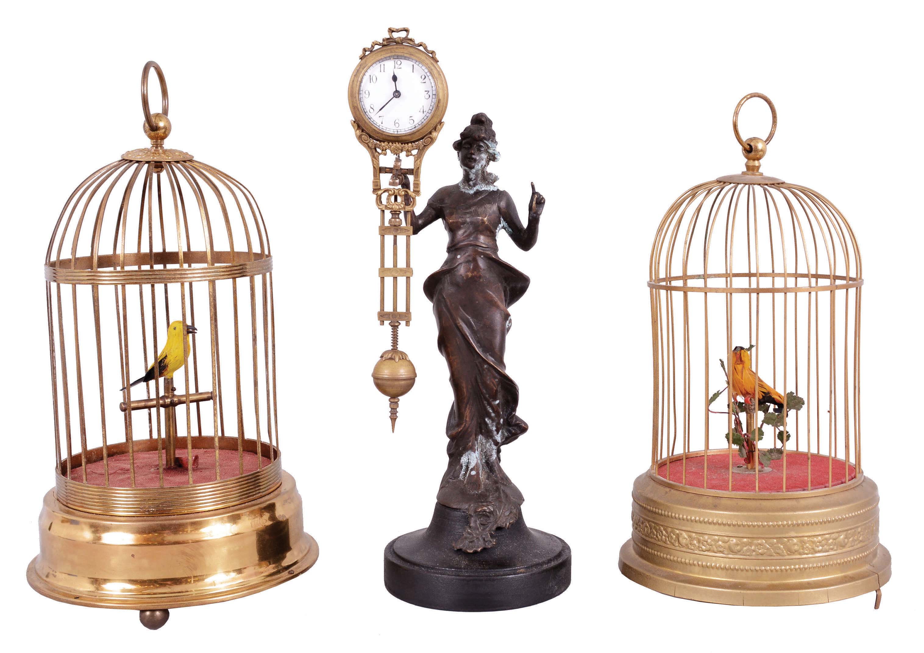 Singing birds- 2 (Two) Singing birds and one swinging mystery clock: German made yellow signing birds in brass cages and one Junghans-style reproduction mystery clock inspired by the "Diana" model. — Antique Clocks Price Guide
