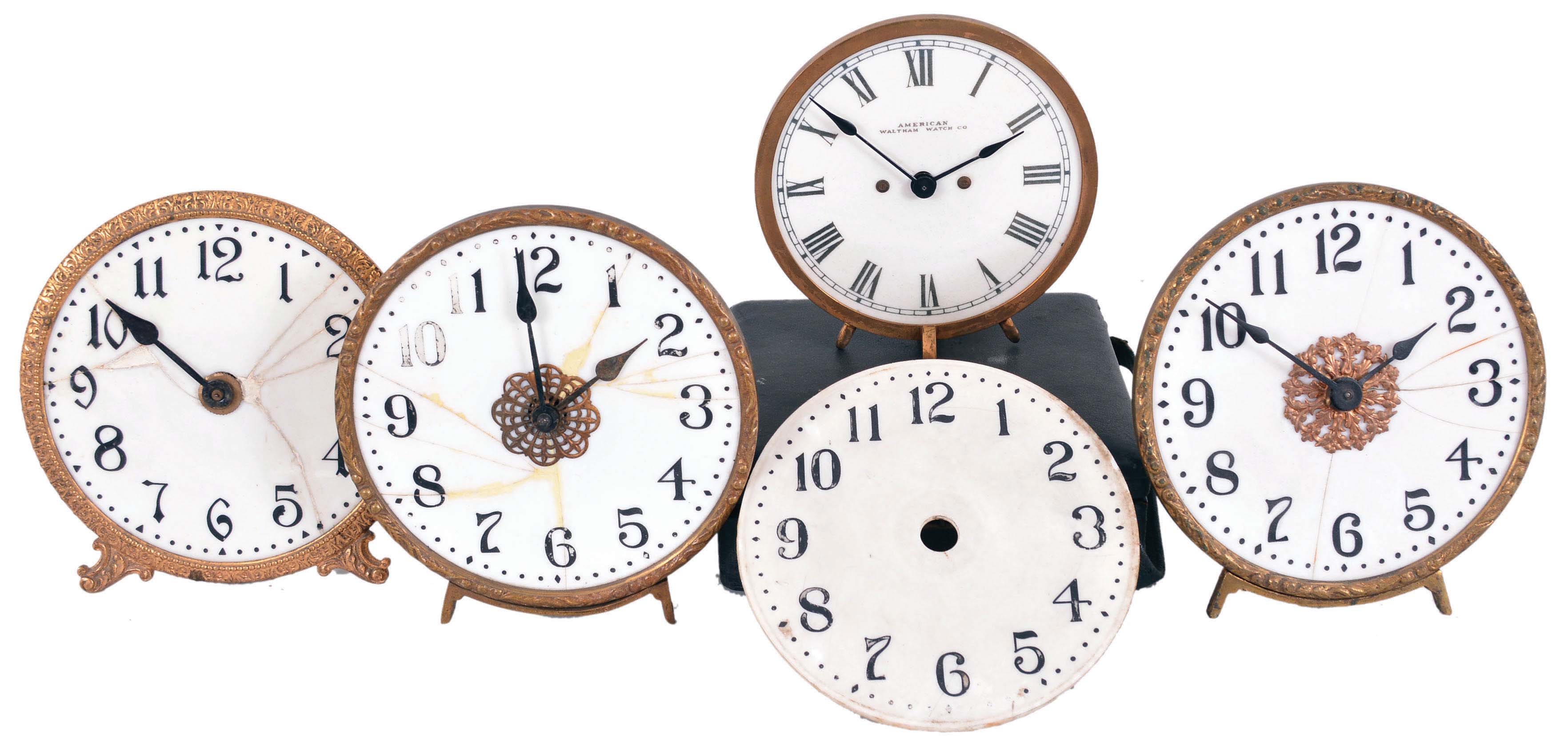 Clocks- 4 (Four) illuminated milk glass clocks, 30 hour, time only clocks, spring-driven balance wheel movements with 5 inch dials. One by the American Waltham Watch Co. comes in a velvet lined case. Of the other three, two are complete. An additional, unbroken dial is included in the lot. — Antique Clocks Price Guide