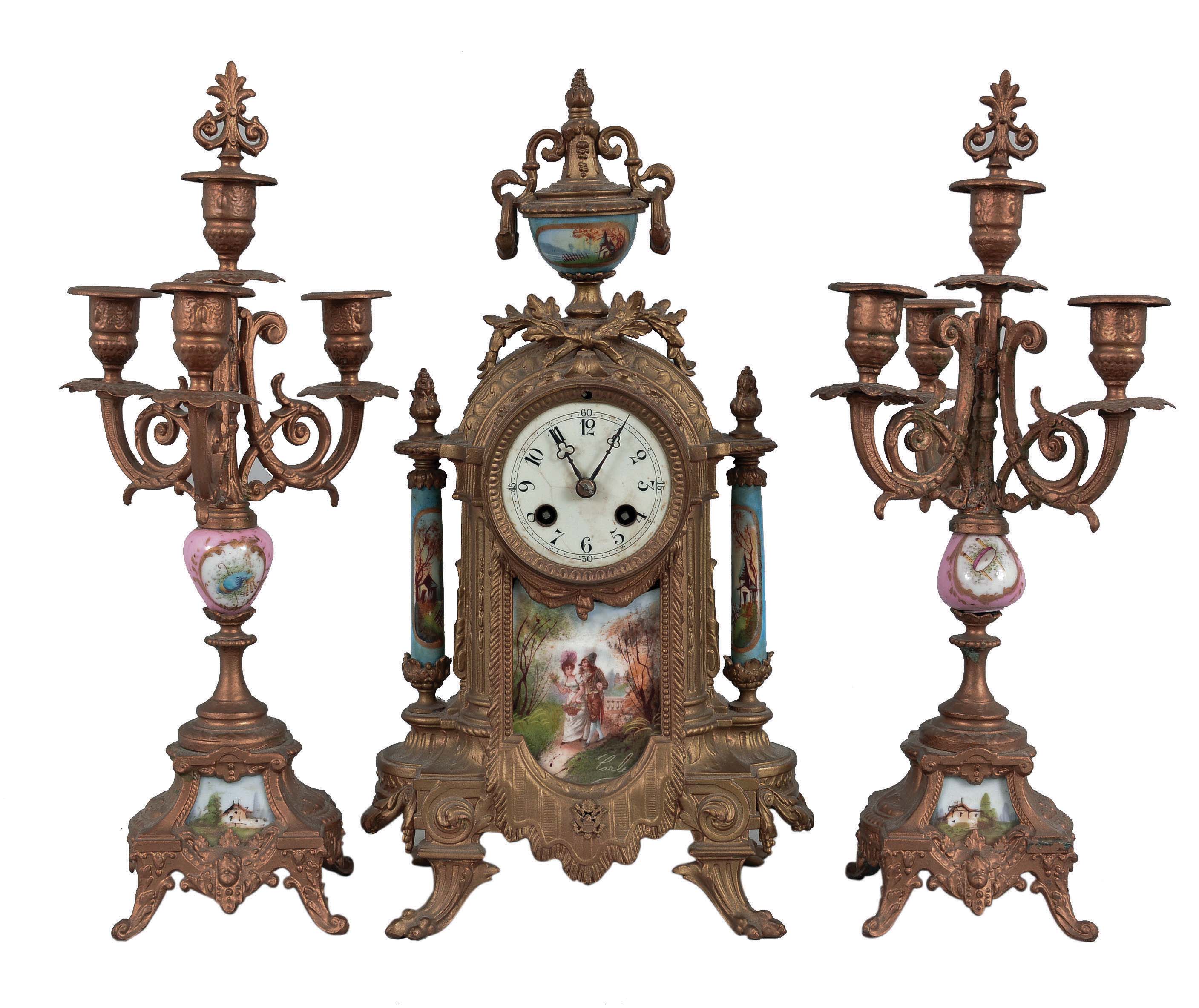 Clocks- 2 (Two) French Cast: (1) Japy Freres, Paris for Tiffany & Comp., three piece mantel garniture, 8 day, time and strike, spring-driven pendule de Paris movement in an ornate cast case with gold finish, painted porcelain panels signed "Carle" and matching candelabra, c1860; (2) France, figural clock, 8 day, time and strike with alarm, spring-driven pendule de Paris movement with in a gilt brass case cast in the form of a female figure holding a bird, all mounted on an ebonized wood base. — Antique Clocks Price Guide