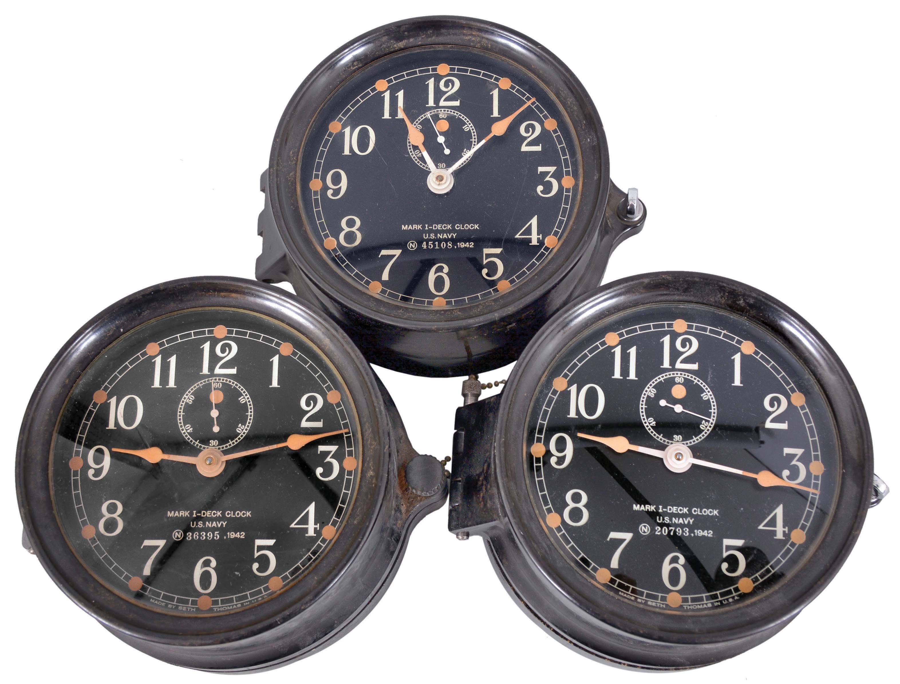 Clocks- 3 (Three) Seth Thomas Deck Clocks: Seth Thomas Clock Co., Thomaston, Conn., for U.S. Navy, "Mark I-Deck Clock", 8 day, time only, spring-driven balance wheel movements in black phenolic cases with rear wind, black dial with subsidiary seconds, all dated 1942. — Antique Clocks Price Guide