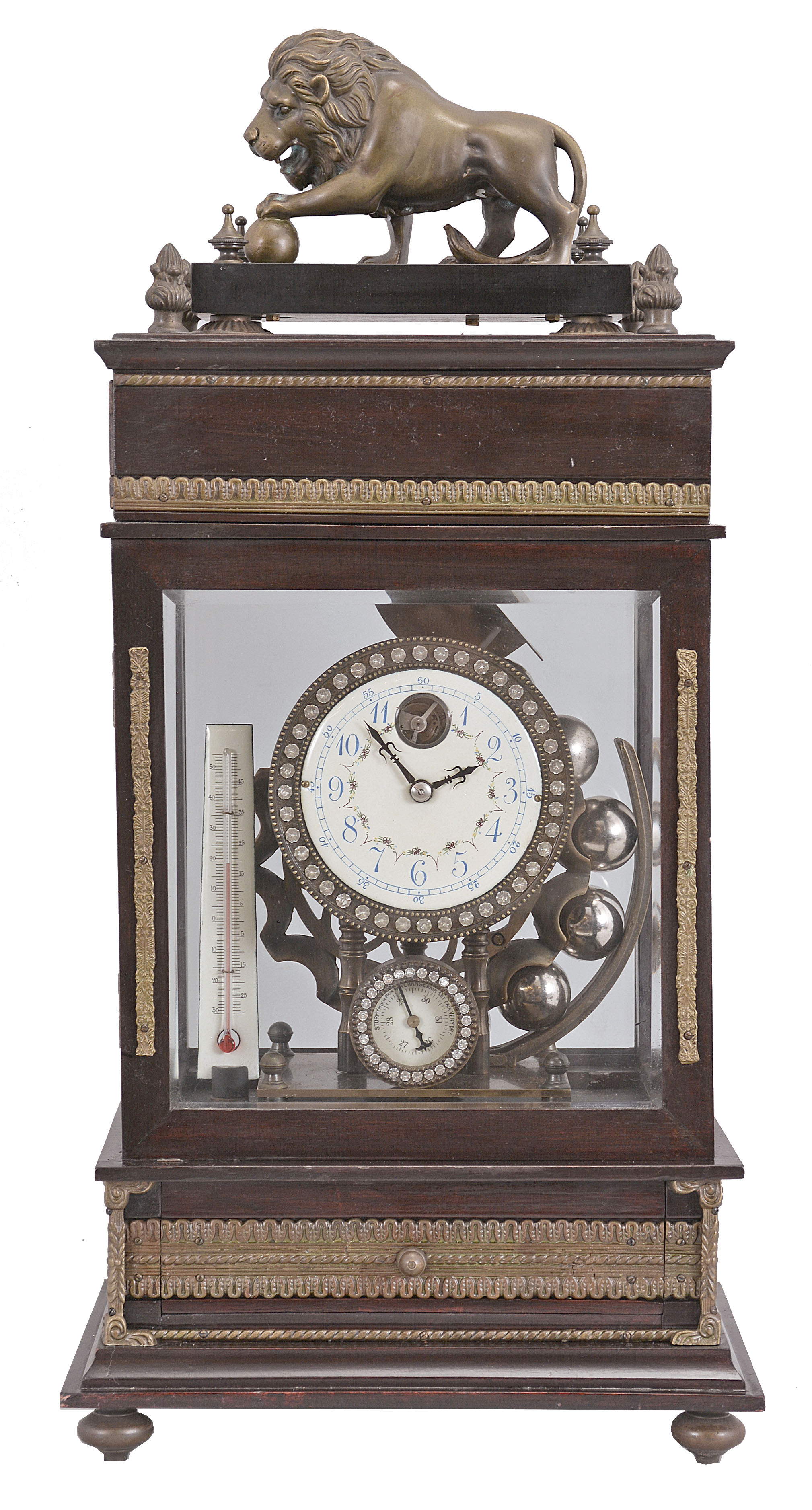 Reproduction Ferris wheel gravity timepiece, 8 day, time only, weight driven balance wheel movement in a glazed wood case with applied brass ornaments, polychrome enamel dial, a small barometer dial below, and alcohol thermometer adjacent, all surmounted by a patinated brass lion. — Antique Clocks Price Guide