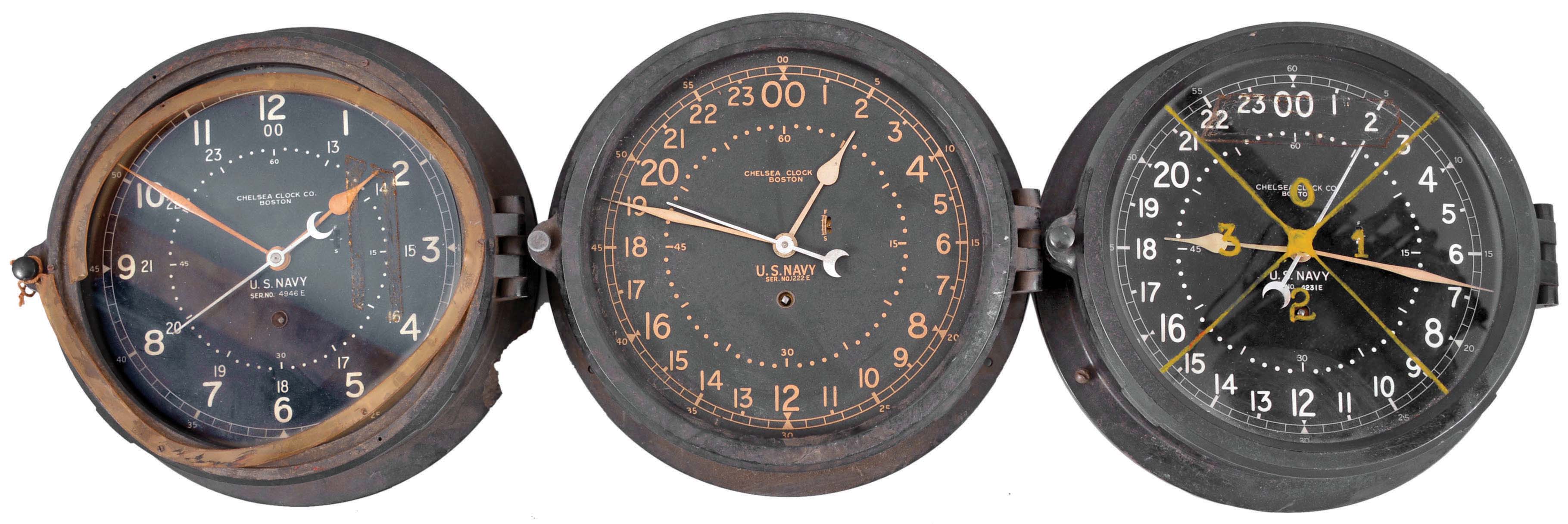 Clocks- 6 (Six) Chelsea Engine Room: Chelsea Clock Co., Boston, for U.S. Navy, "12E Deck & Engine Room Clock", 8 day, time only, spring-driven balance wheel movement in black phenolic cases with hinged bezels, all but one with 8.5 inch black dial, 12 and 24 hour variants, and center seconds. — Antique Clocks Price Guide