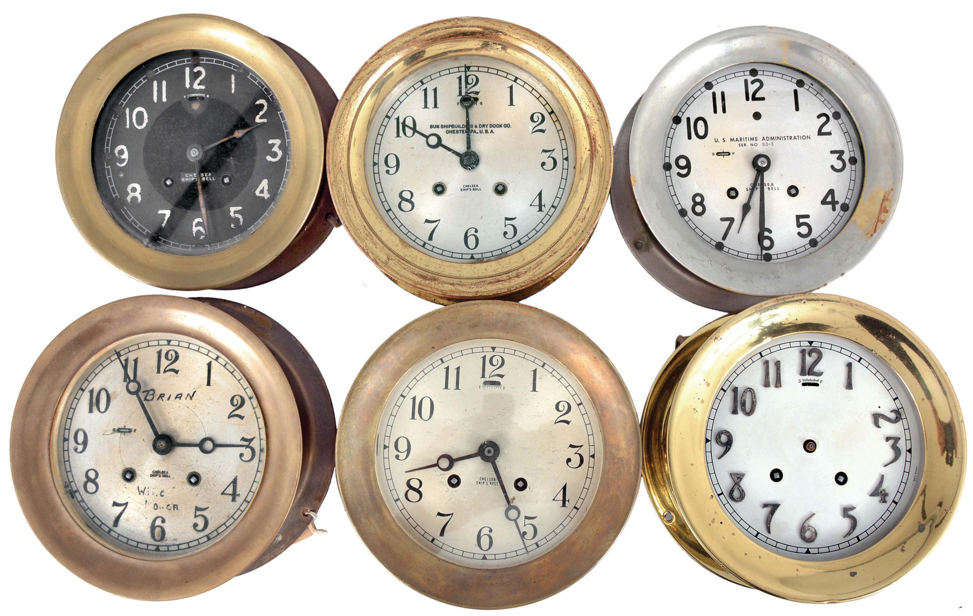Clocks- 6 (Six) Chelsea Ship's Bell: Chelsea Clock Co., Boston, marine clocks, 8 day, time and ship's strike, spring-driven balance wheel movements in brass or nickel plated cases, two with hinged bezels and four with screw-on bezels, one with a black dial and the rest with 5.5 inch silvered dials, one signed "U.S. Maritime Administration" and another "Sun Shipbuilding & Dry Dock Co. ". — Antique Clocks Price Guide