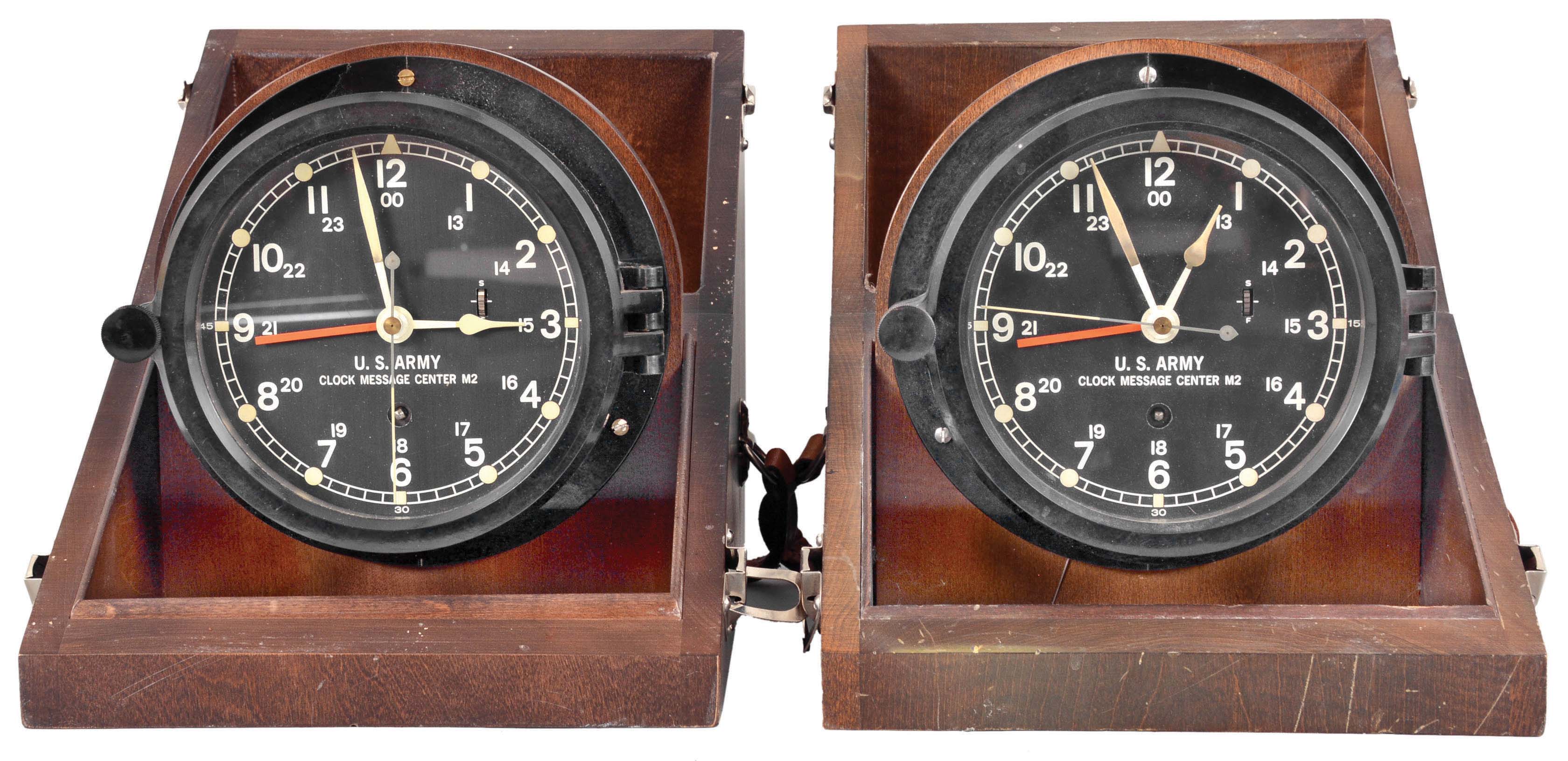 Clocks- 2 (Two) Message Center: Chelsea Clock Co., Boston, "U.S. Army Clock Message Center, Mark 2" military timepieces, 8 day, time only, spring-driven balance wheel movements in black phenolic cases with black dials showing 12 and 24 hours, center seconds, and secondary hour hand to show GMT, all in tilt-out wooden carrying cases with leather straps. — Antique Clocks Price Guide