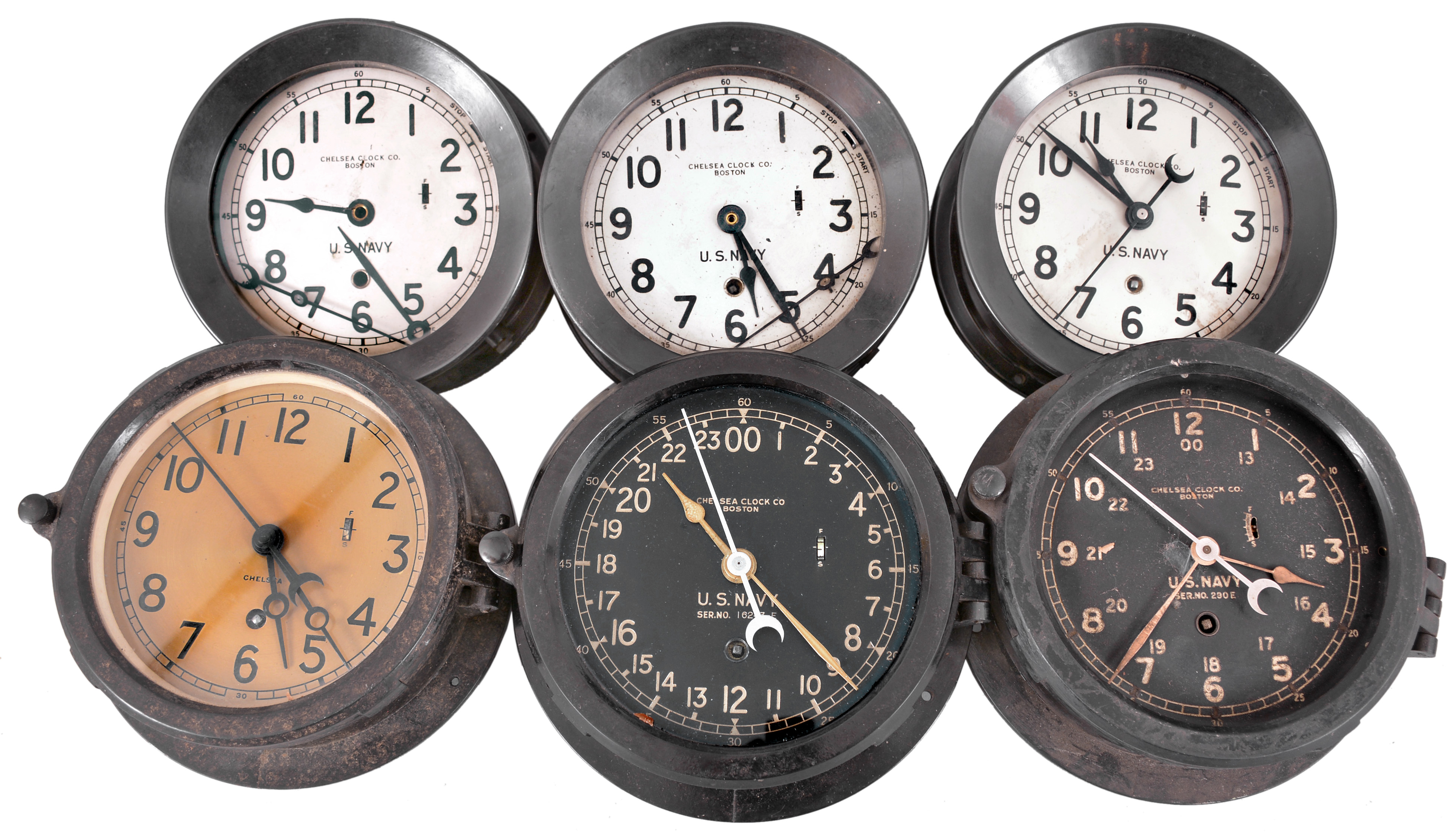 Clocks- 6 (Six) Chelsea Deck or Engine Room: Chelsea Clock Co., Boston, for U.S. Navy, "Deck & Engine Room" clocks, 8 day, time only, spring-driven balance wheel movements in black phenolic cases with hinged bezels, white, black and silvered dials with center seconds. — Antique Clocks Price Guide