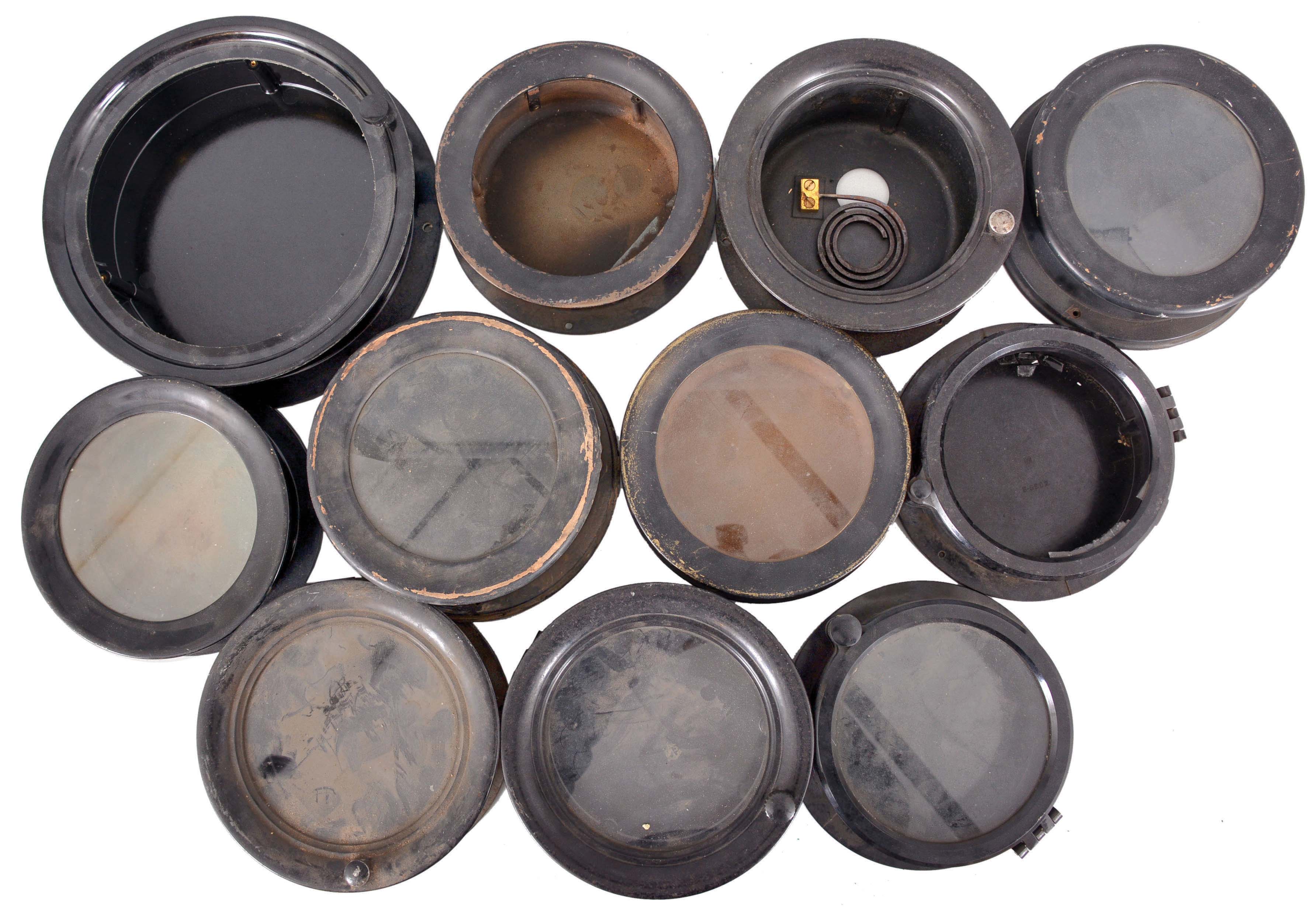 18 (Eighteen) Marine Clock Cases: black painted wood and brass, black phenolic, and nickel-plated brass marine clock cases by various makers in assorted sizes. A number of nickel plated wall mounting plates are also included. — Antique Clocks Price Guide
