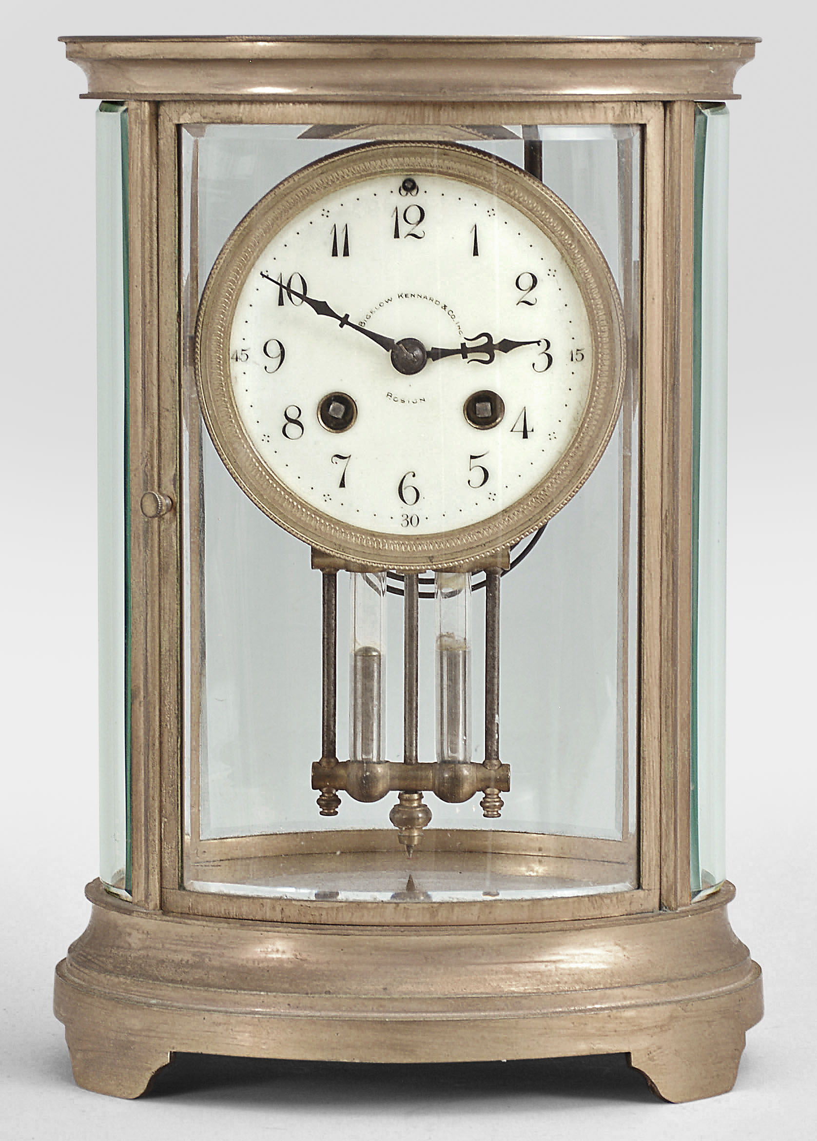 Charles Hour, Paris, for Bigelow, Kennard, & Co., Boston, crystal regulator, 8 day, time and strike, spring driven pendule de Paris movement with Brocot escapement and compensating pendulum in an oval form glazed gilt brass case with cream colored enamel dial with arabic numerals and blued steel hands. — Antique Clocks Price Guide
