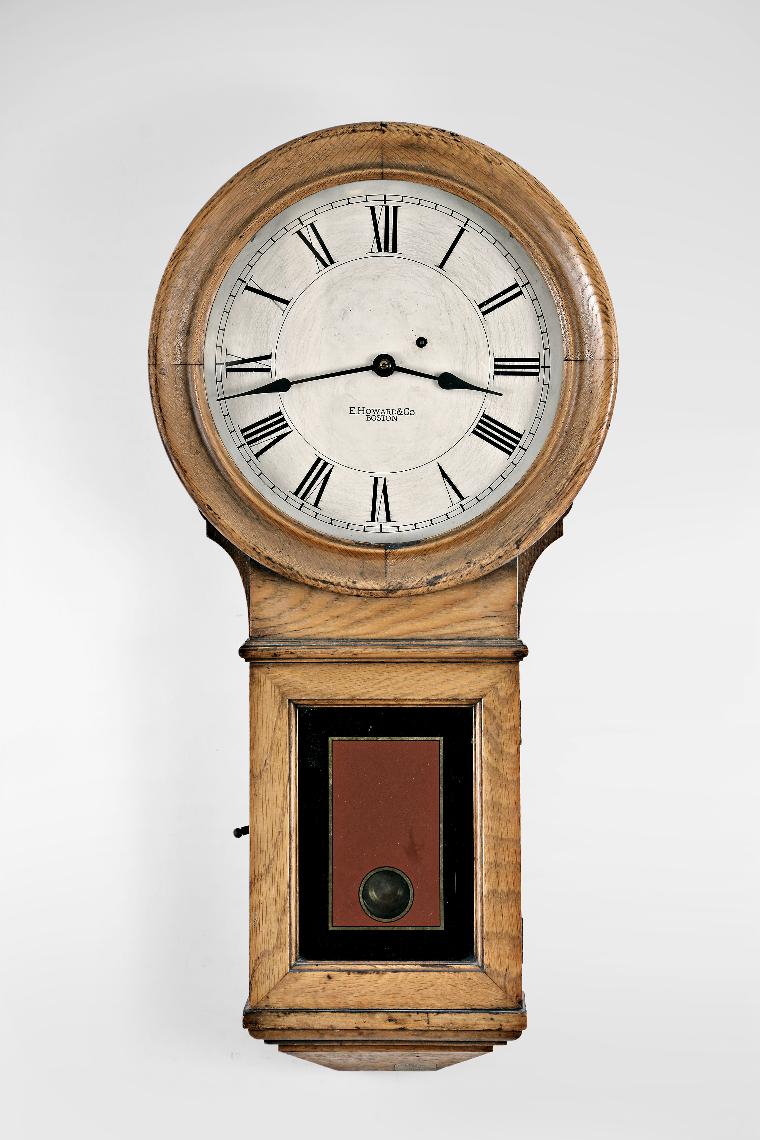 E. Howard & Co., Boston, Mass., "Regulator No. 70" 8 day, weight brass movement wall timepiece. This example once resided in a firehouse as evidenced by the label attached on the bottom that reads "City of Boston, Fire-a-90 " — Antique Clocks Price Guide