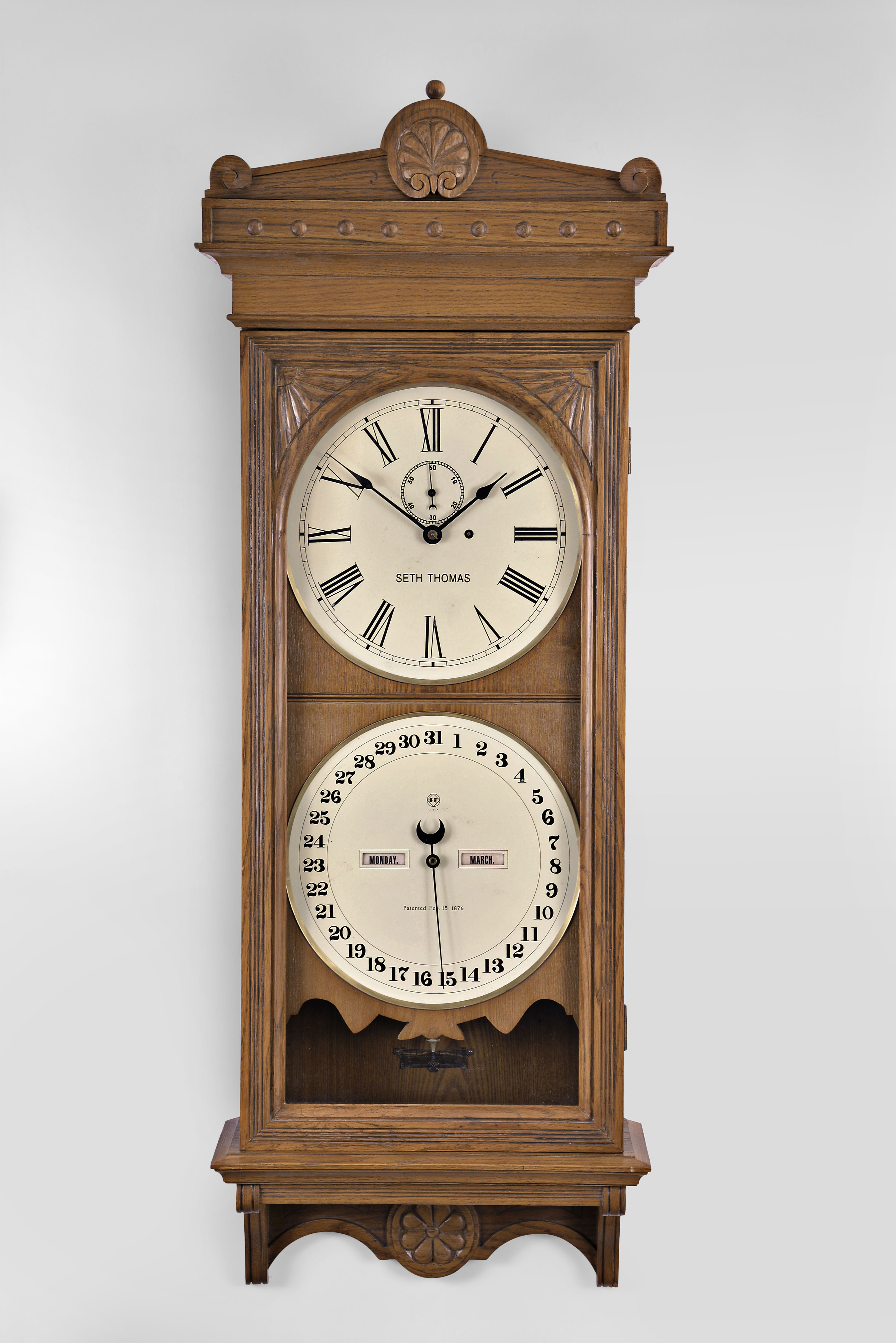 Seth Thomas Office Calendar No. 13 (reproduction) with a weight driven 8 day timepiece movement with maintaining power and a perpetual calendar mechanism (R. T. Andrews style) in an oak case. — Antique Clocks Price Guide