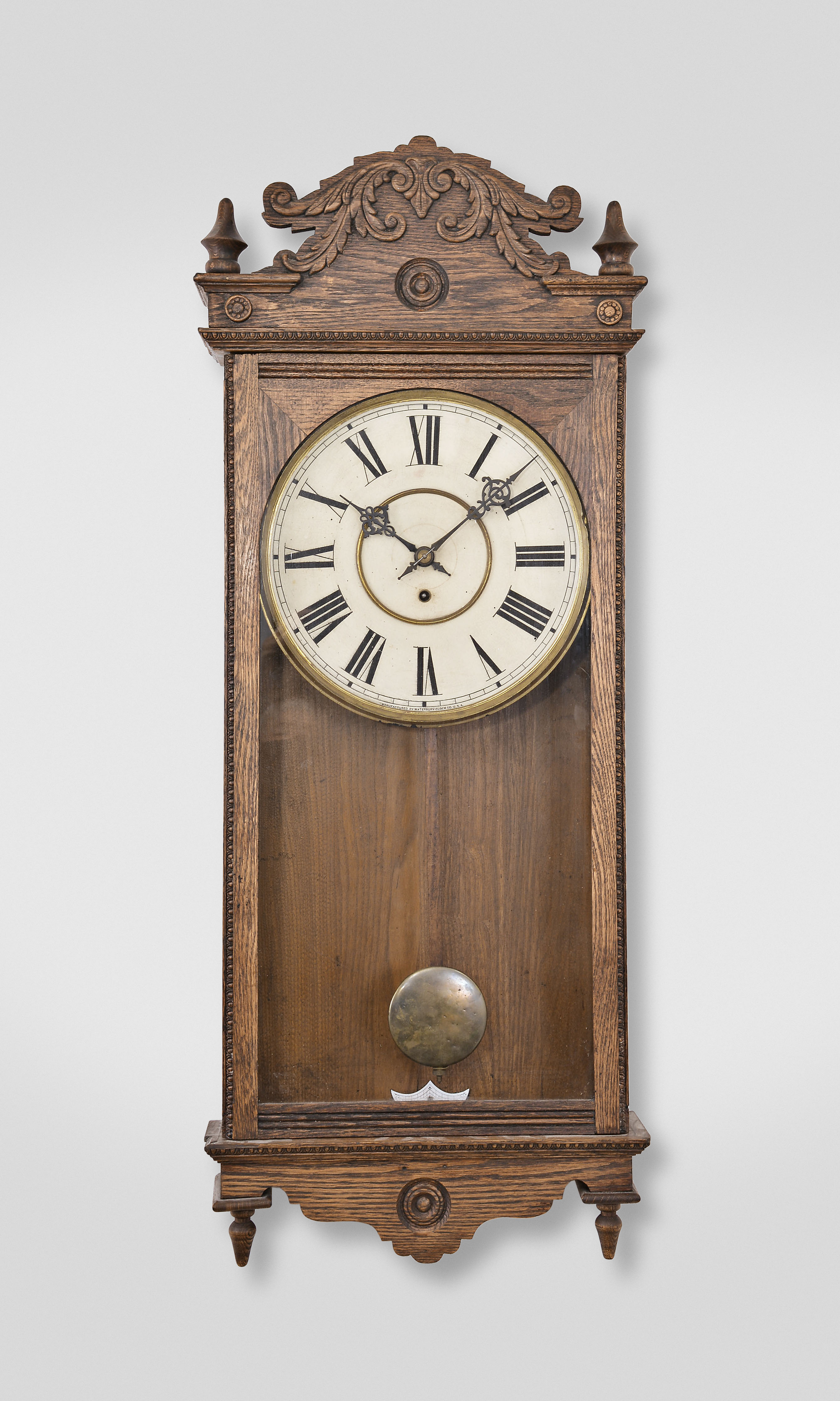 Waterbury Clock Co., Waterbury, Conn., "Fostoria" wall clock, 8 day, time only, spring driven movement in an oak case with 12 inch painted metal dial. — Antique Clocks Price Guide