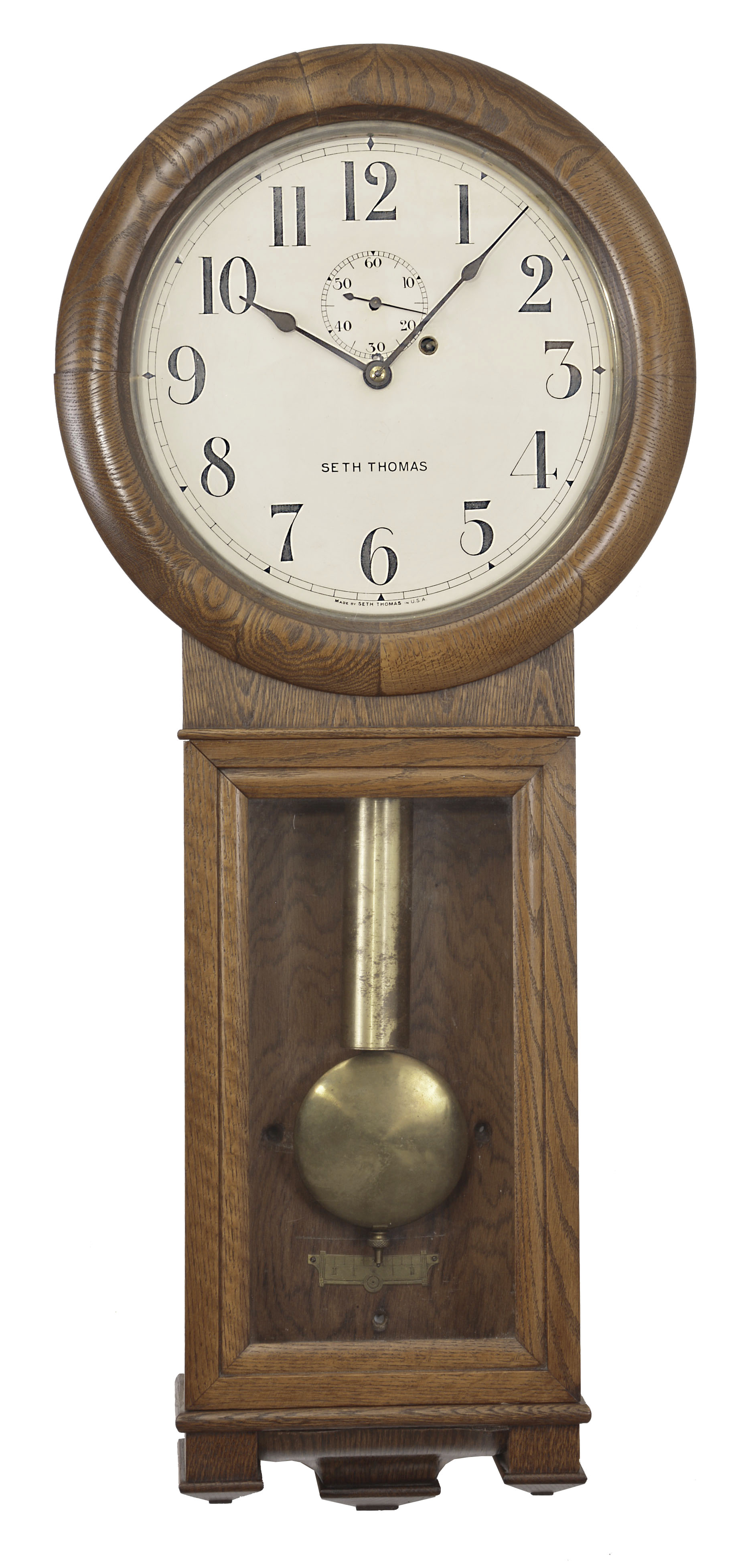 Seth Thomas Clock Co., Thomaston, Conn., "Regulator No. 2" hanging timepiece, 8 day, weight driven movement with maintaining power in an oak case with painted metal dial. — Antique Clocks Price Guide
