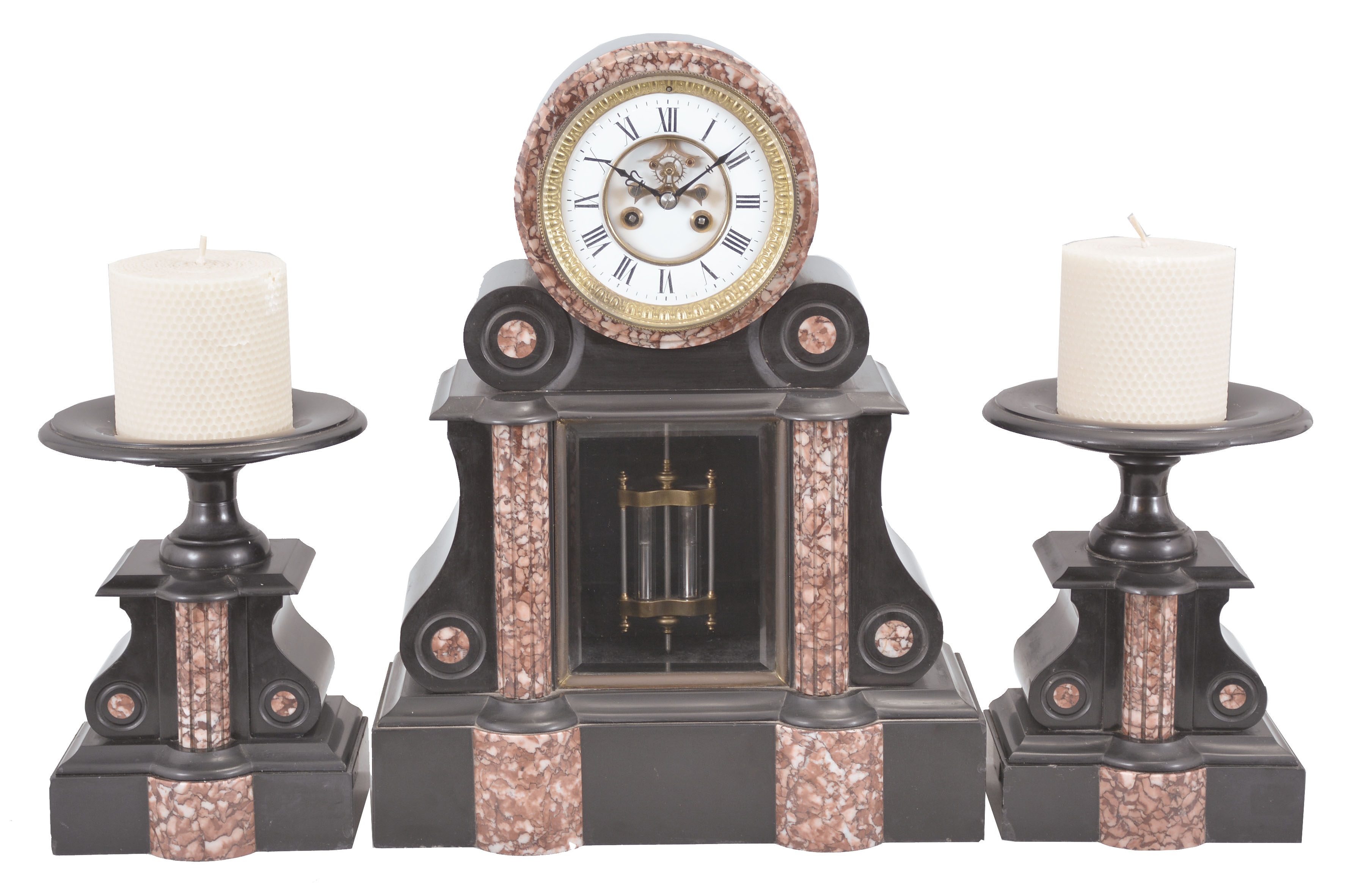Fritz Marti et Fils, Vieux-Charmont, France, three piece mantel garniture, 8 day, time and strike, spring driven pendule de Paris movement with visible Brocot escapement and compensating pendulum in a black slate case with variegated red marble columns and accents, white two-piece enamel dial, beveled glasses, and blued steel hands with two matching tazze and candles. — Antique Clocks Price Guide