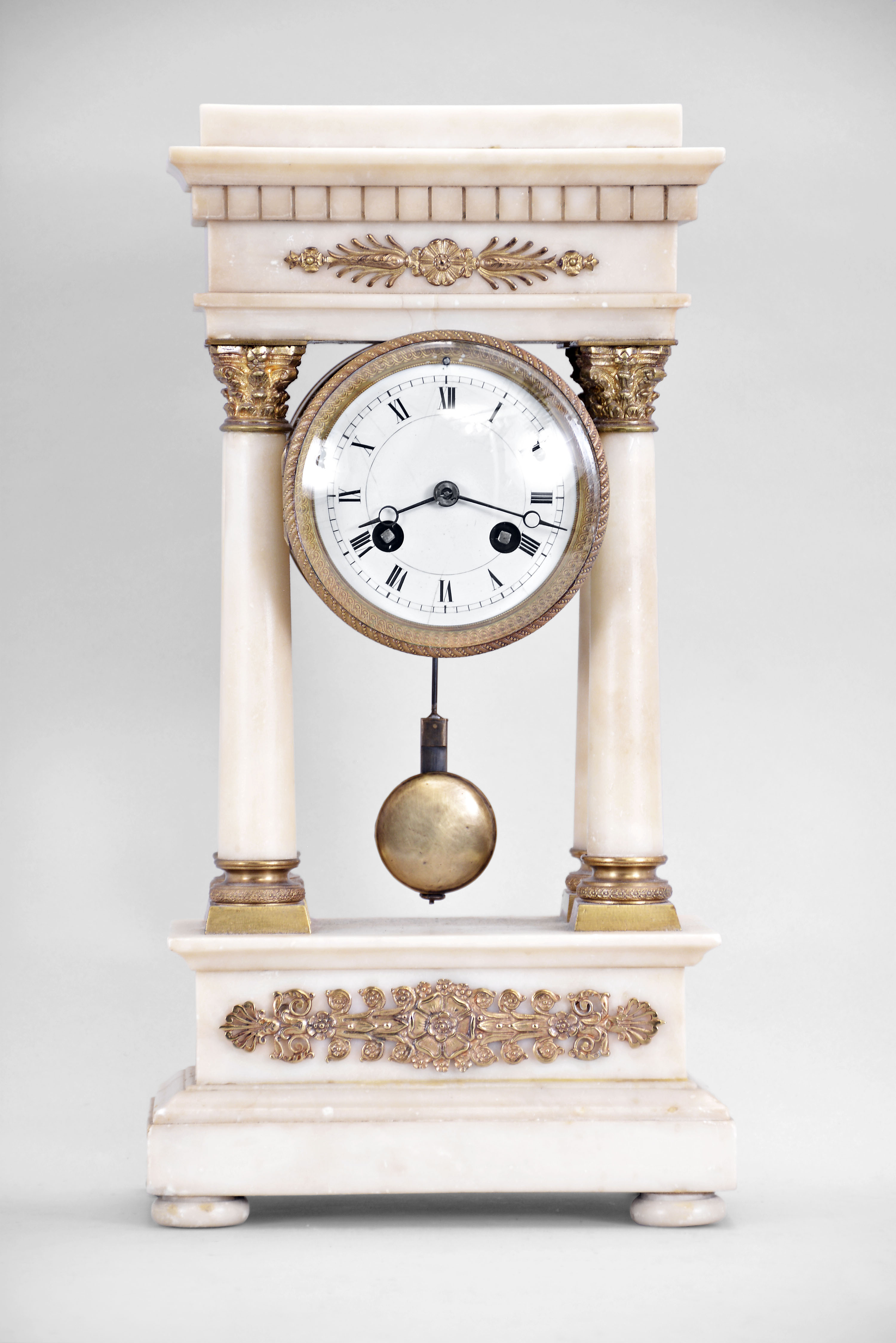 S. Marti, Paris, miniature portico clock, 8 day, time and strike, spring driven pendule de Paris movement in a white marble case with four columns, cast gilt ornaments, Corinthian column bases, and capitals, Roman numeral white enamel dial with blued steel Breguet hands. — Antique Clocks Price Guide
