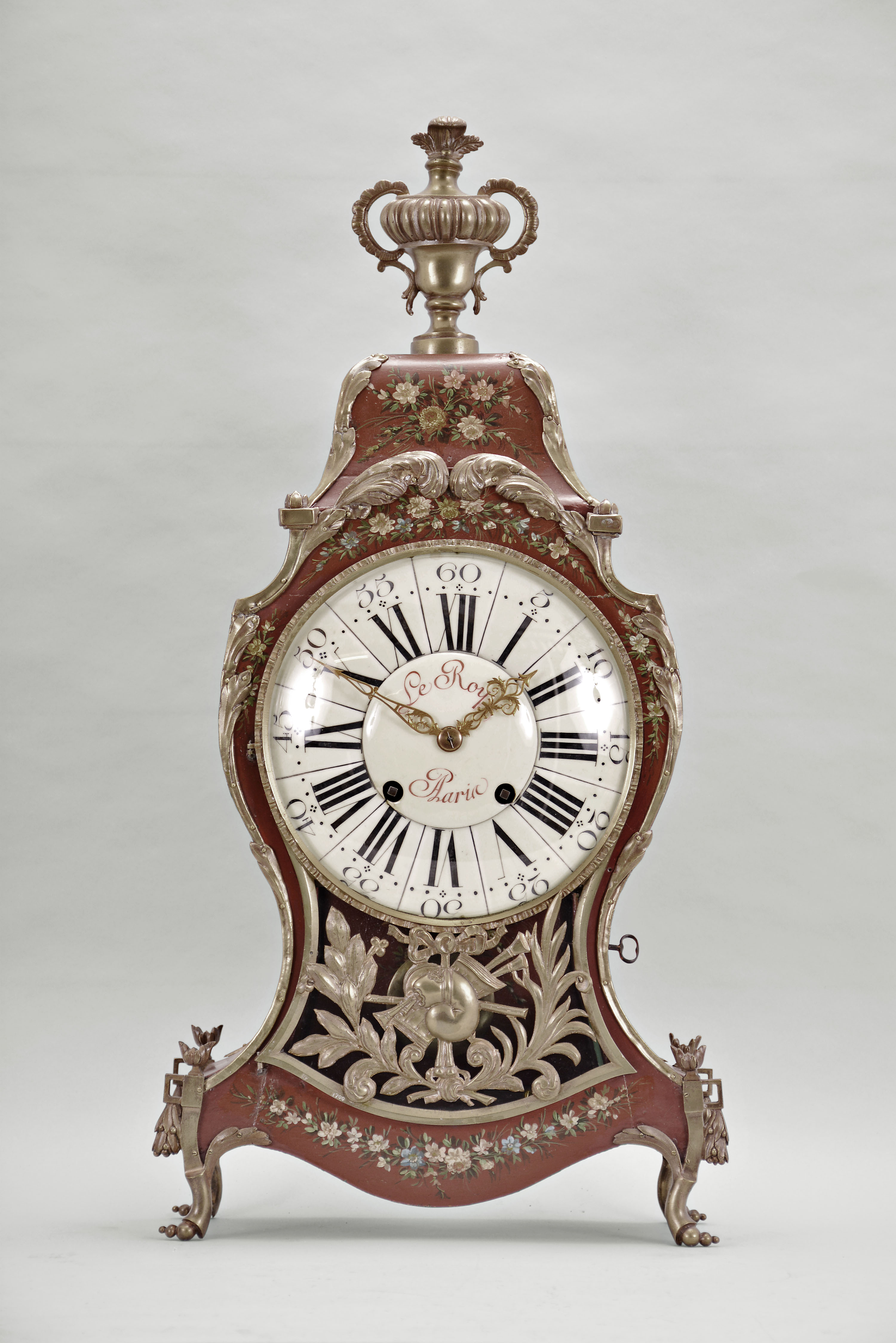 Switzerland, a late 18th century Neuchateloise bracket clock, the red, hardwood case and bracket with painted floral ornament, the bracket with polychrome musical trophy, and with foliate, repousse mounts, and top with cast bronze urn finial, faux thirteen piece enamel dial, eight day movement with rectangular plates, rear mounted strike work, crown wheel escapement, silk thread suspension, and Dutch striking on two bells, the back plate marked "FRFC 689 " — Antique Clocks Price Guide
