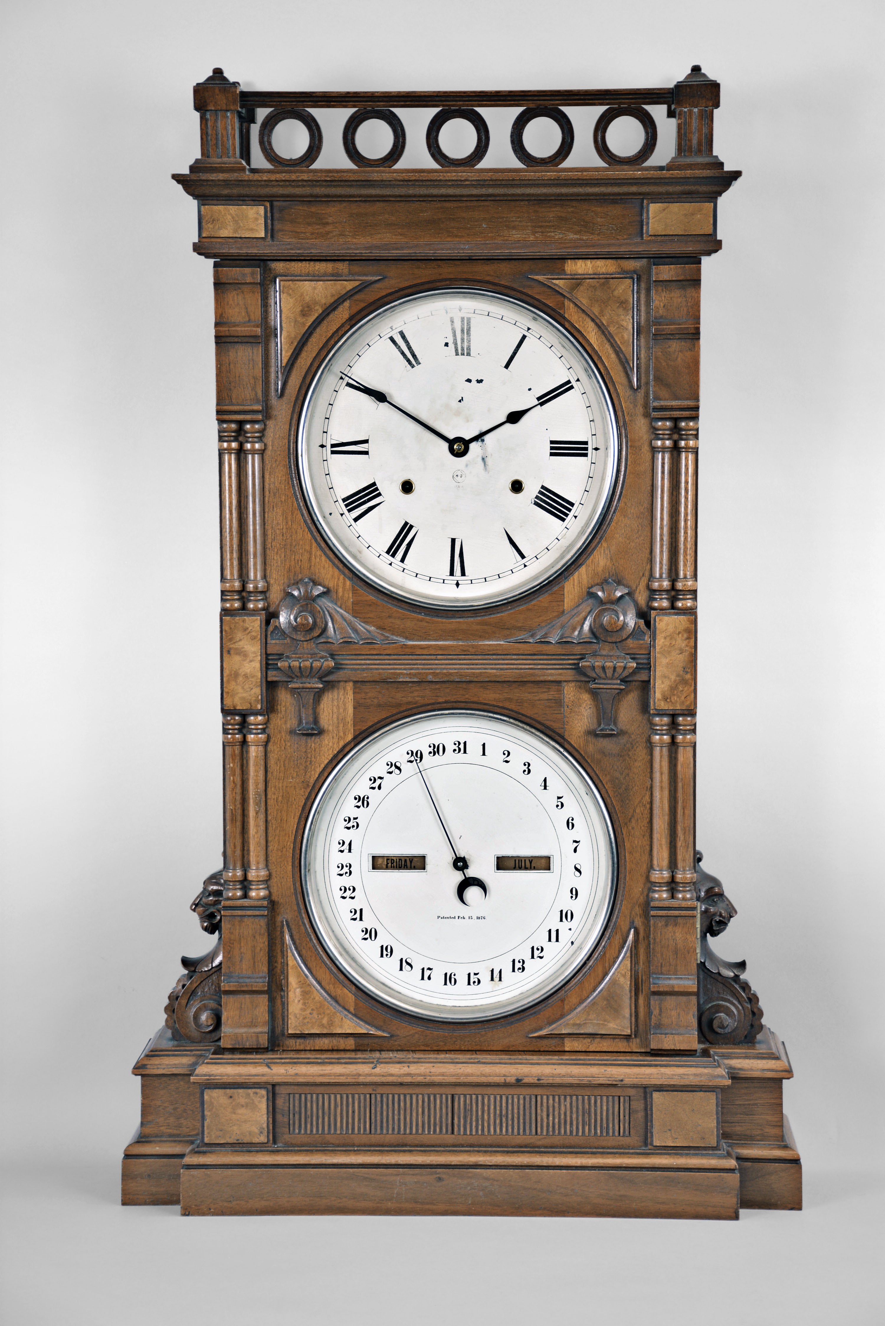 Seth Thomas Clock Co., Thomaston, Conn., "Parlor Calendar No. 10 Variant" shelf clock with a weight driven 8 day time and strike lyre movement and a R. T. Andrews patented perpetual calendar mechanism in a walnut case with burl accents. — Antique Clocks Price Guide