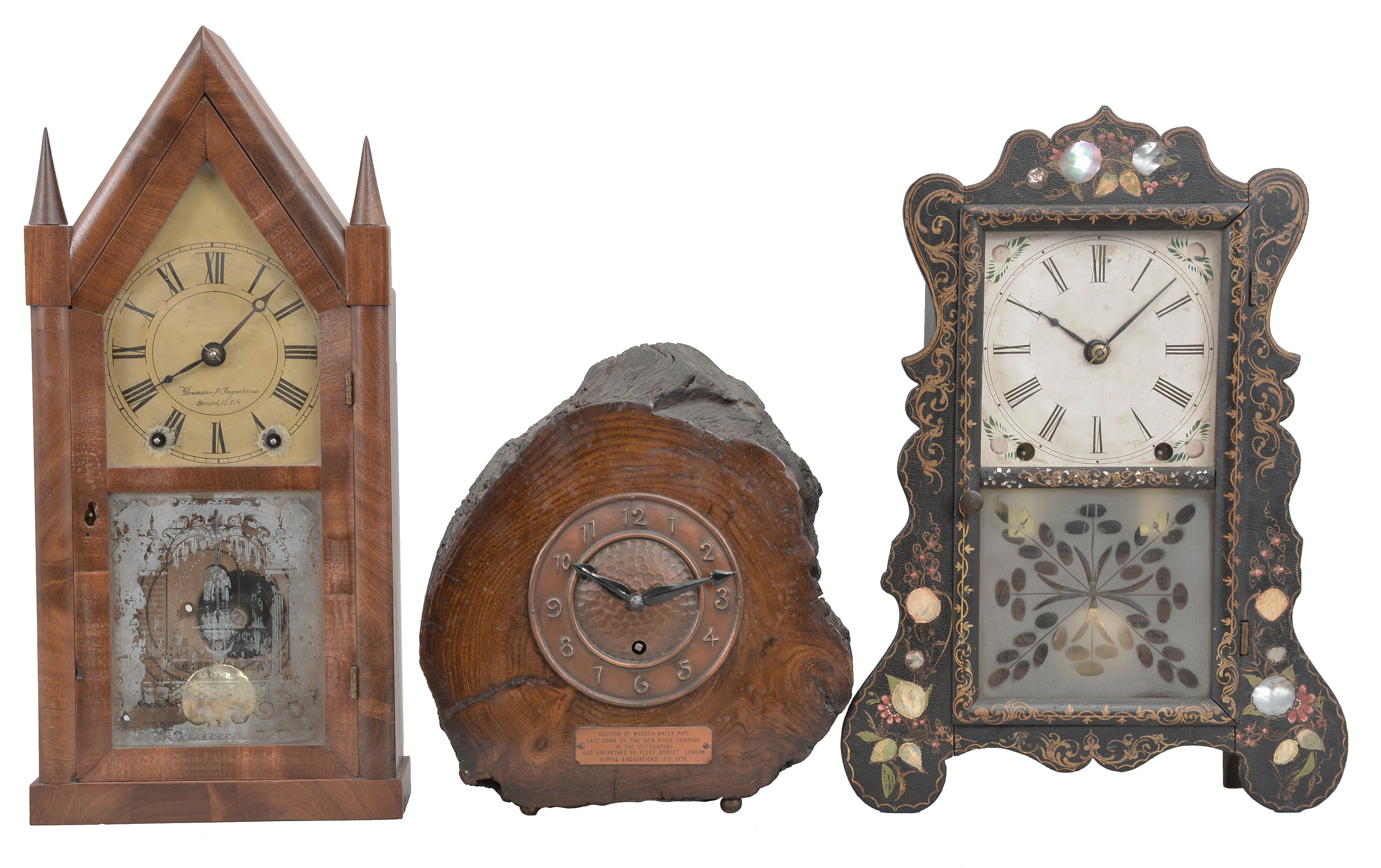 Clocks- 5 (Five): (1) Brewster Manufacturing Co., Bristol, Conn., mantel clock, 8 day, time and strike, spring driven movement in a black wood case with mother of pearl and painted decorations, c1852; (2) Brewster & Ingrahams, Bristol, Conn., sharp gothic or steeple clock, 8 day, time and strike, spring driven movement in a walnut veneer case, c1850; (3) England, mantel clock, 8 day, time only, spring driven movement with balance wheel, in wood case that was once a section of water pipe in 17th century London, c1908. (4) Ansonia Brass & Copper Co., Ansonia, Conn., "Gilt Column", 8 day, time and strike, spring driven movement in a walnut veneer case, c1874; (5) Elisha Manross, Bristol, Conn., miniature ogee shelf clock, 30 hour, time and strike, spring driven movement in a walnut veneer case and William B. Fenn eagle glass, c1850. — Antique Clocks Price Guide
