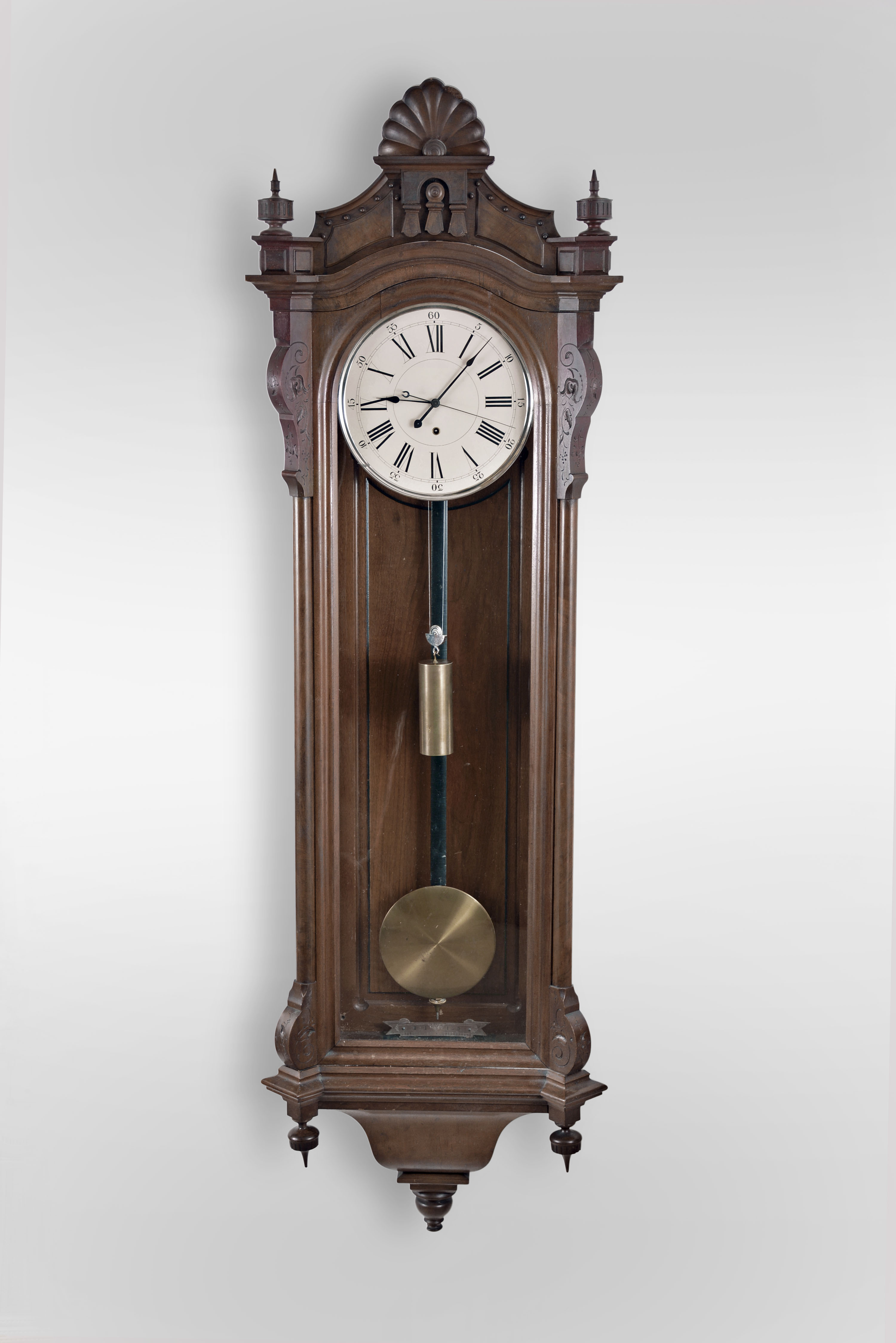 Seth Thomas Clock Co., "Regulator No. 16" hanging jeweler's regulator, 8 day, time only, weight driven movement with Graham dead beat escapement and sweep seconds in a carved walnut case with burl walnut highlights and painted metal dial — Antique Clocks Price Guide